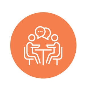 An orange circle with a white graphic of two people talking at a table overlayed on top.