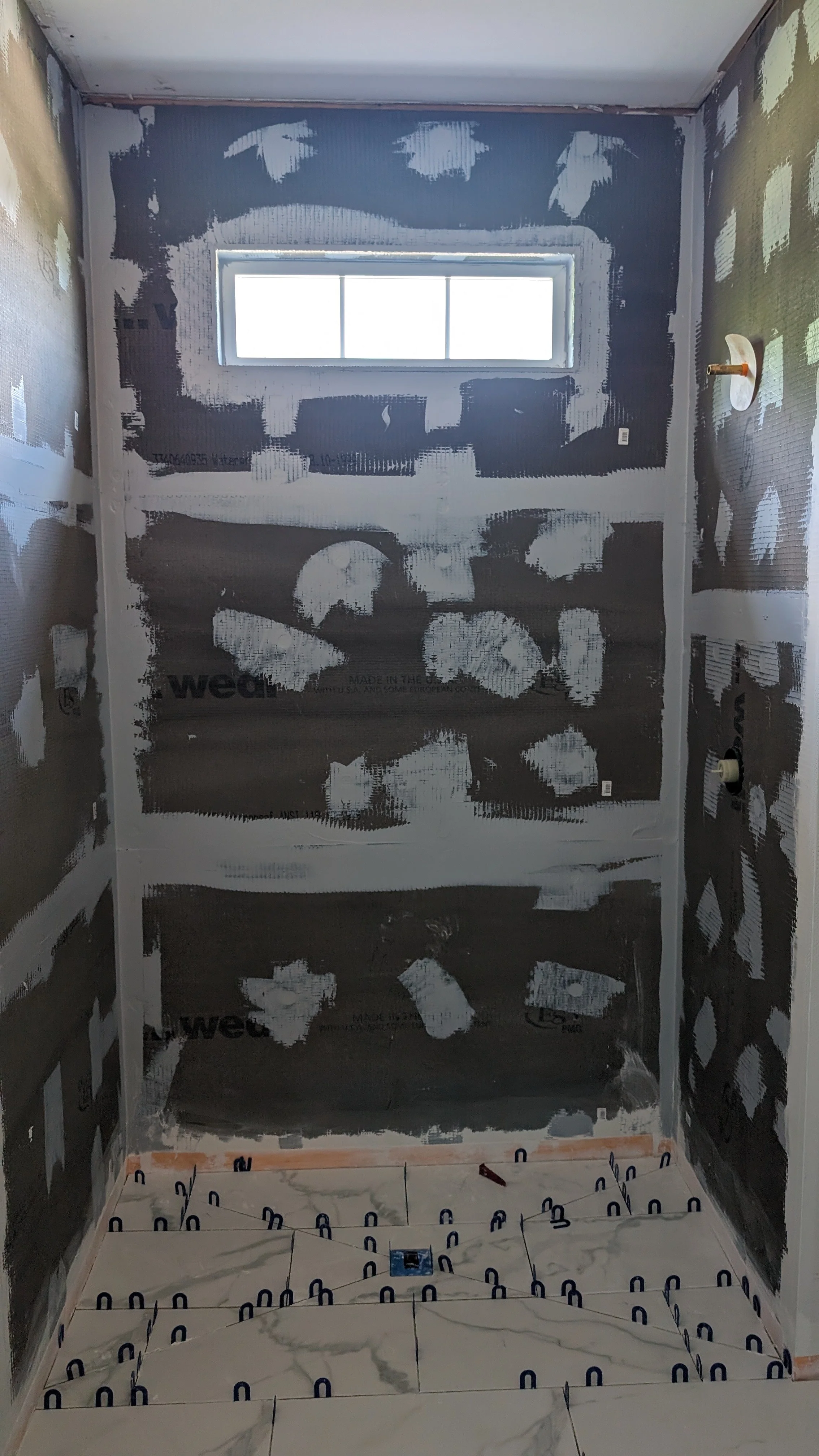 Loveland-bathroom-renovation-laying-tile.jpg