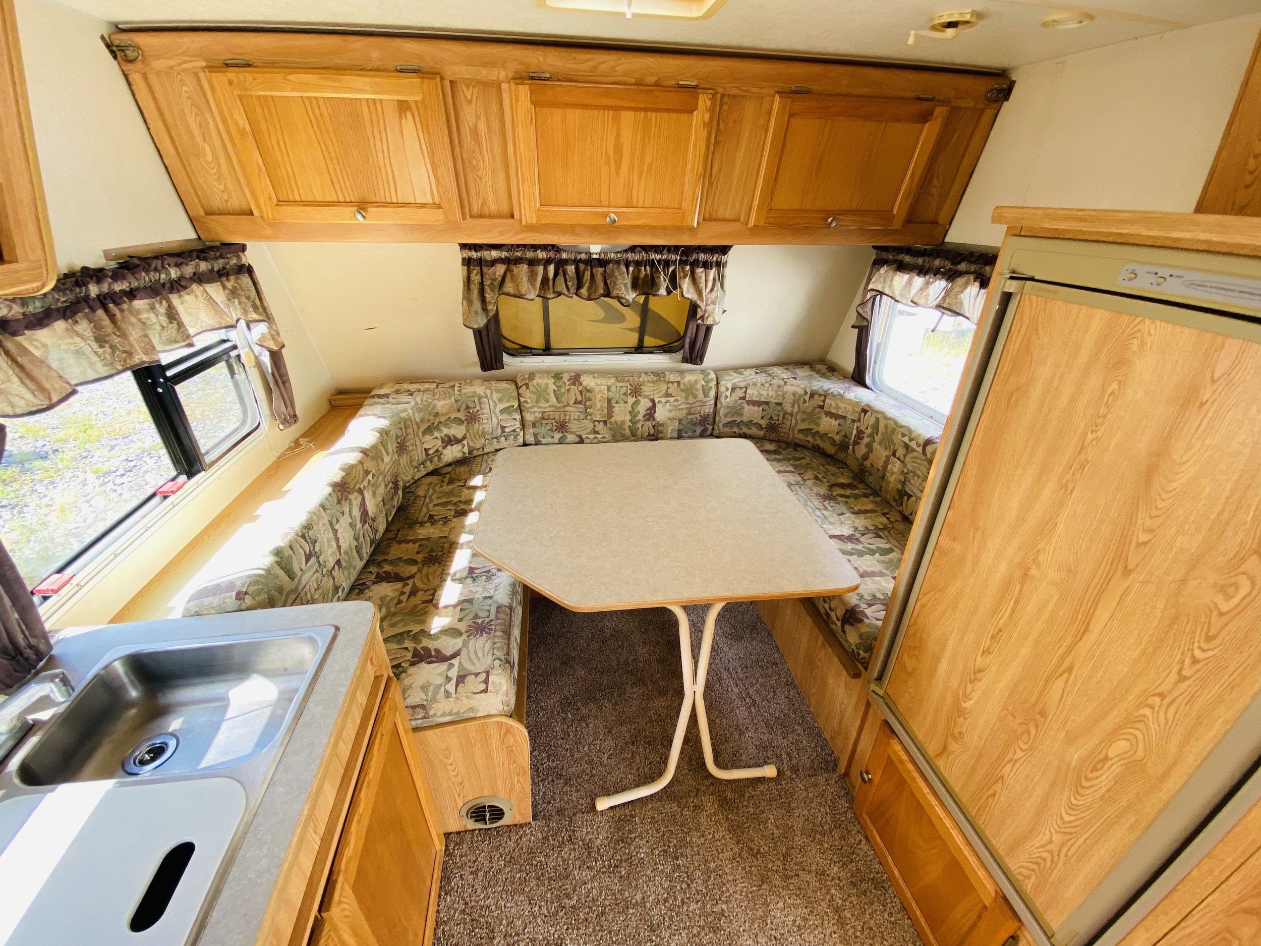 A RV CAMPER FLOOR THAT HAS BEEN REPAIRED AND LOOKS LIKE NEW