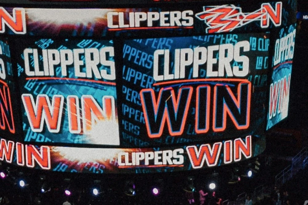 The scoreboard shows the Los Angeles Clippers winning with the word 'WIN' displayed multiple times.