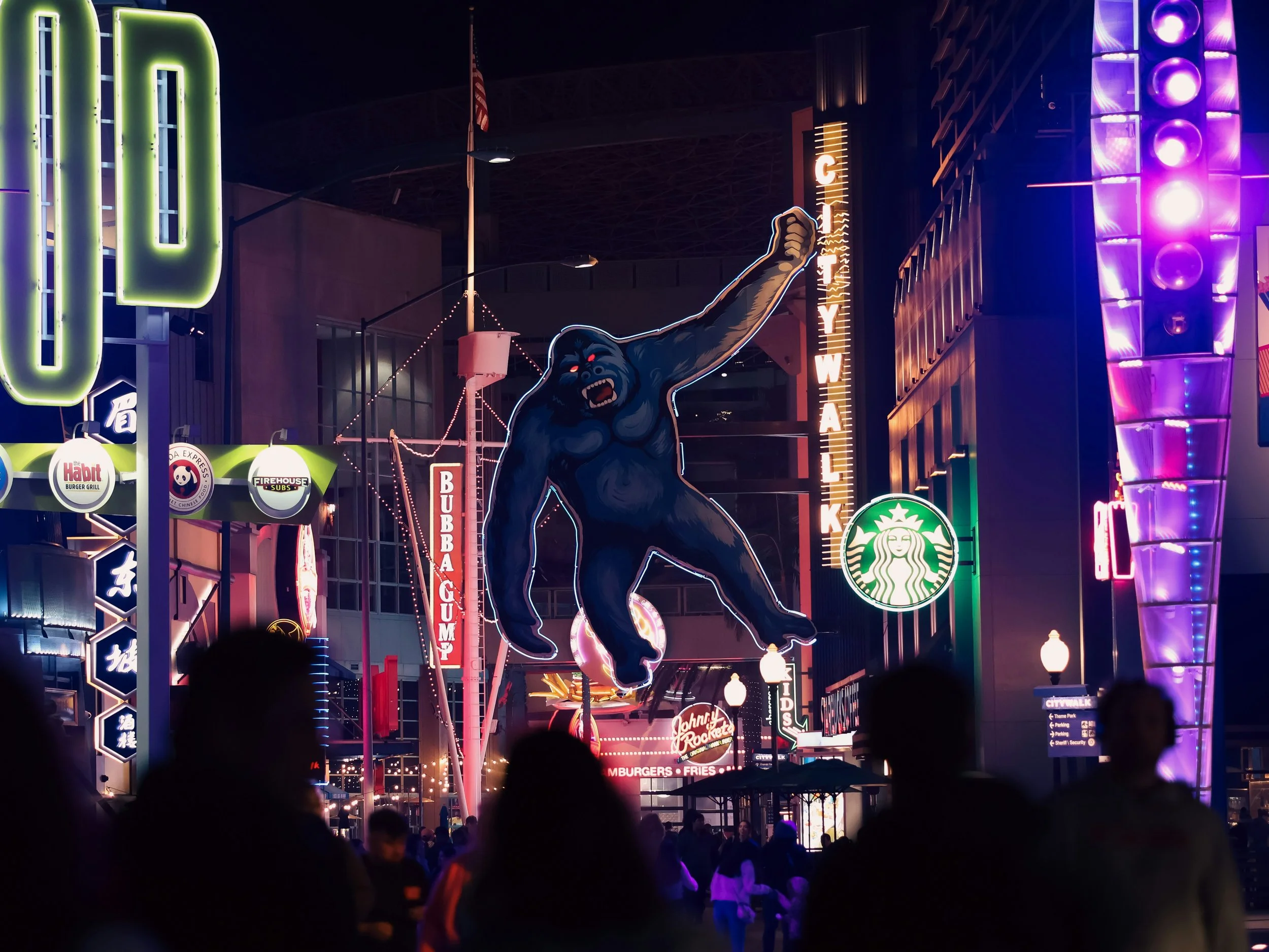 Image of Universal CityWalk light up at night with Large Gorilla sign next to the CityWalk sign