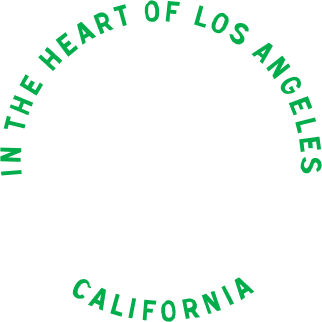 Green text arranged in a circle on a black background reading "In the Heart of Los Angeles California".