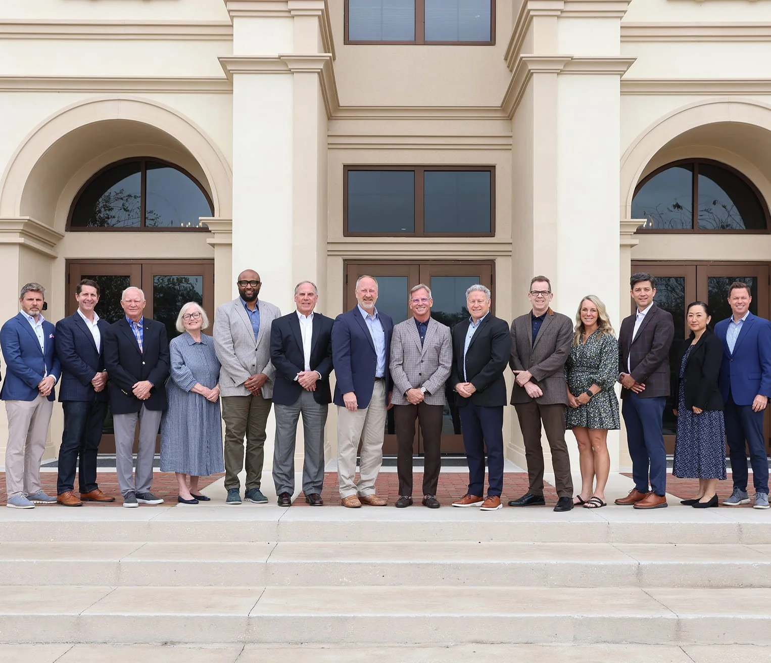 The Geneva School leadership team standing in a line in front of the school.