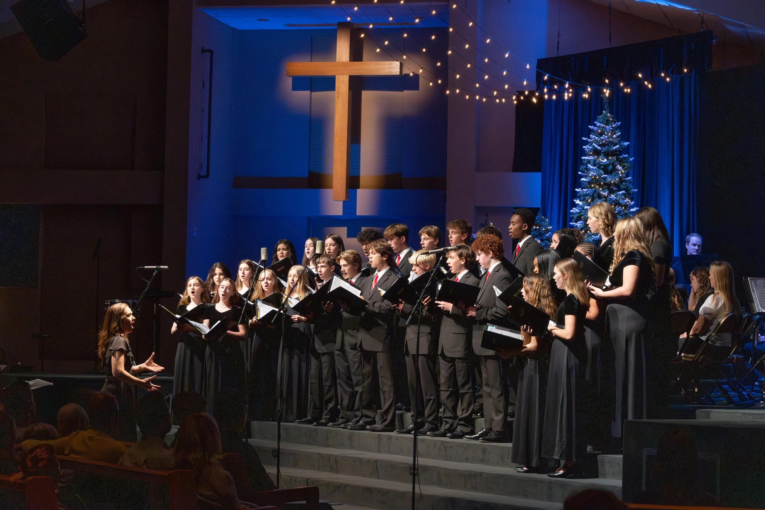 Choir sings under cross