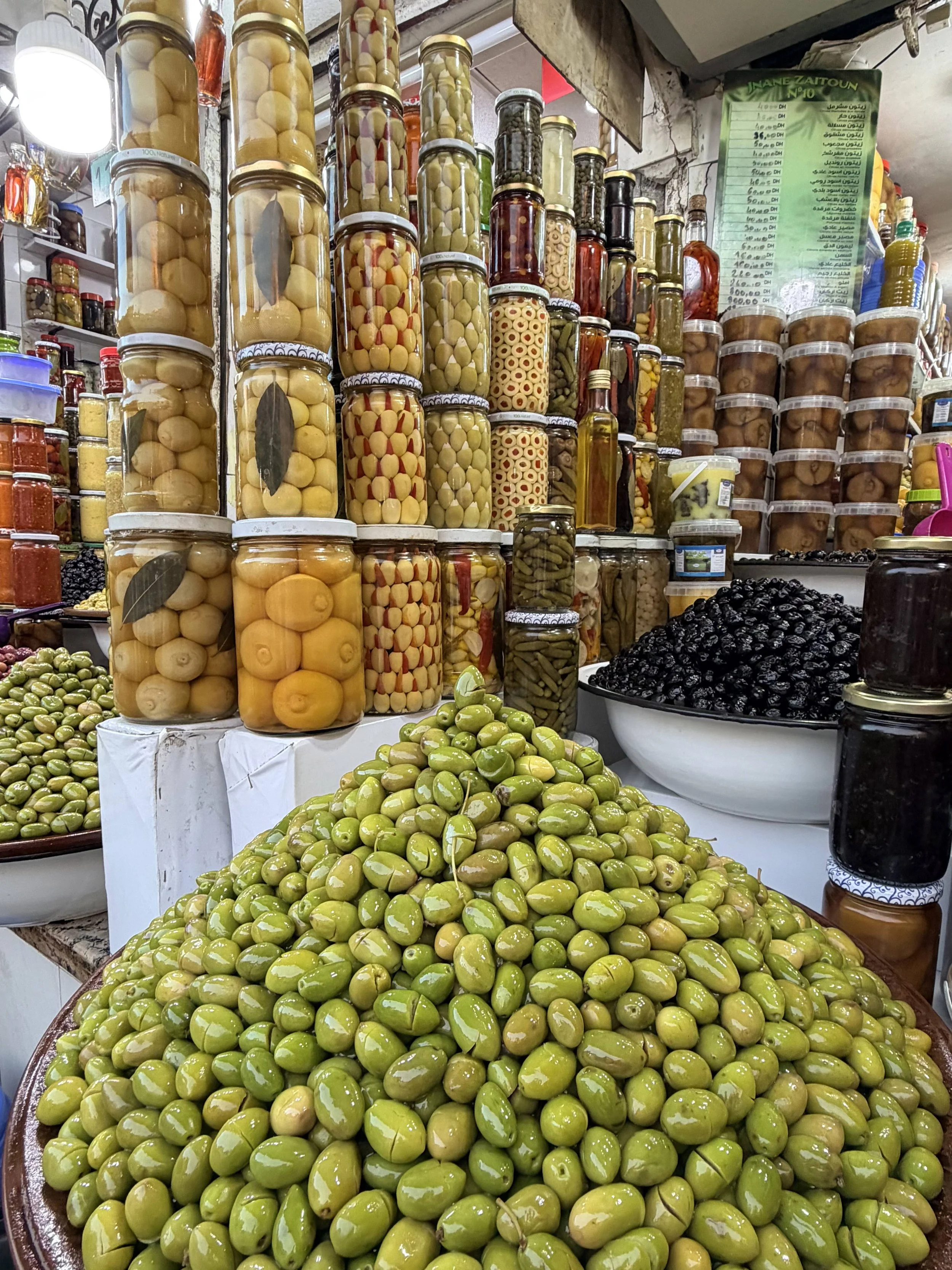 Olives and preserved vegetables displayed at a market stall in Marrakech, part of Morocco’s rich food and market culture.