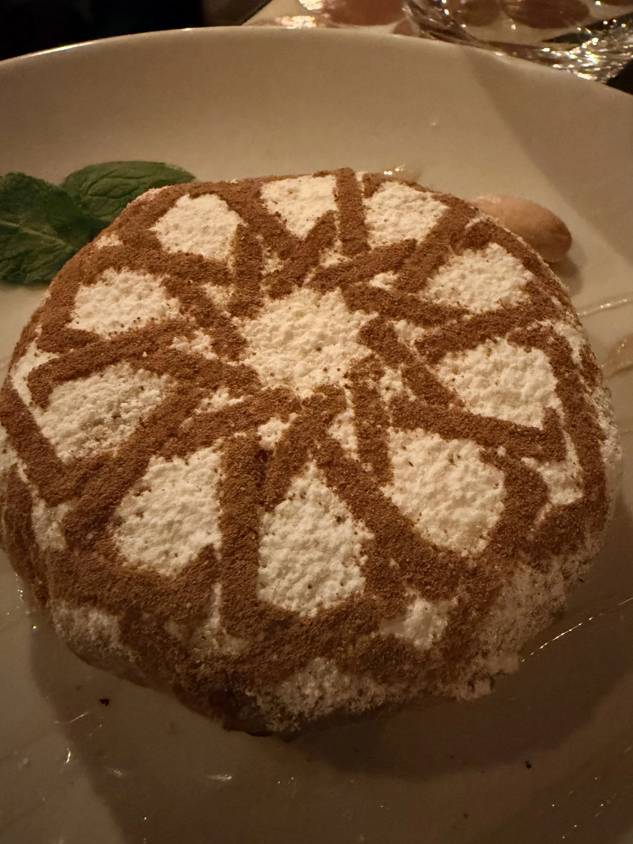 Moroccan pastilla topped with powdered sugar and cinnamon, served as part of a traditional food experience in Morocco.