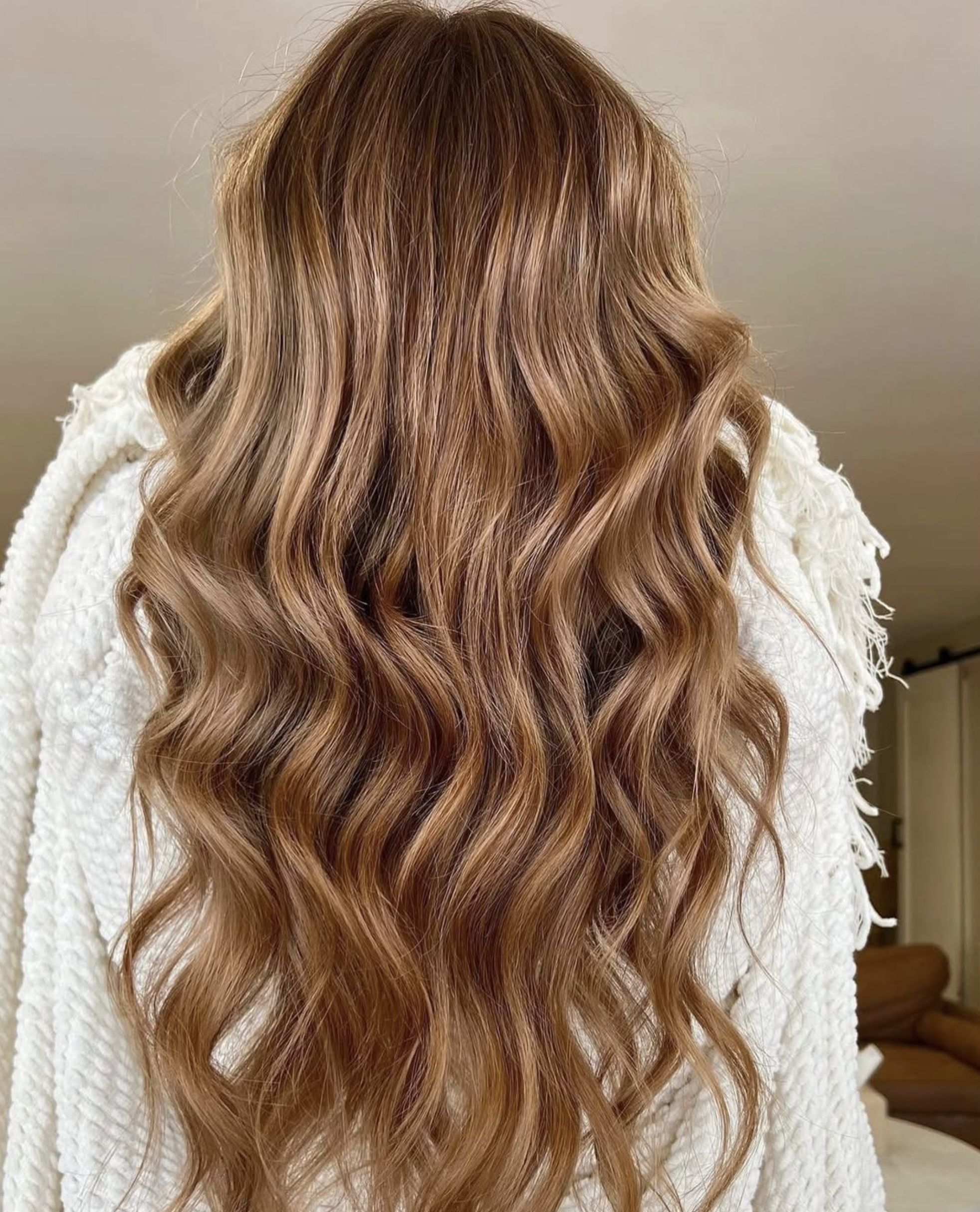 A person with long, wavy, reddish-brown hair.