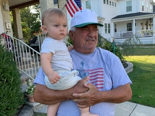 Matt's father, Ron, holding Matt's son, Chet.