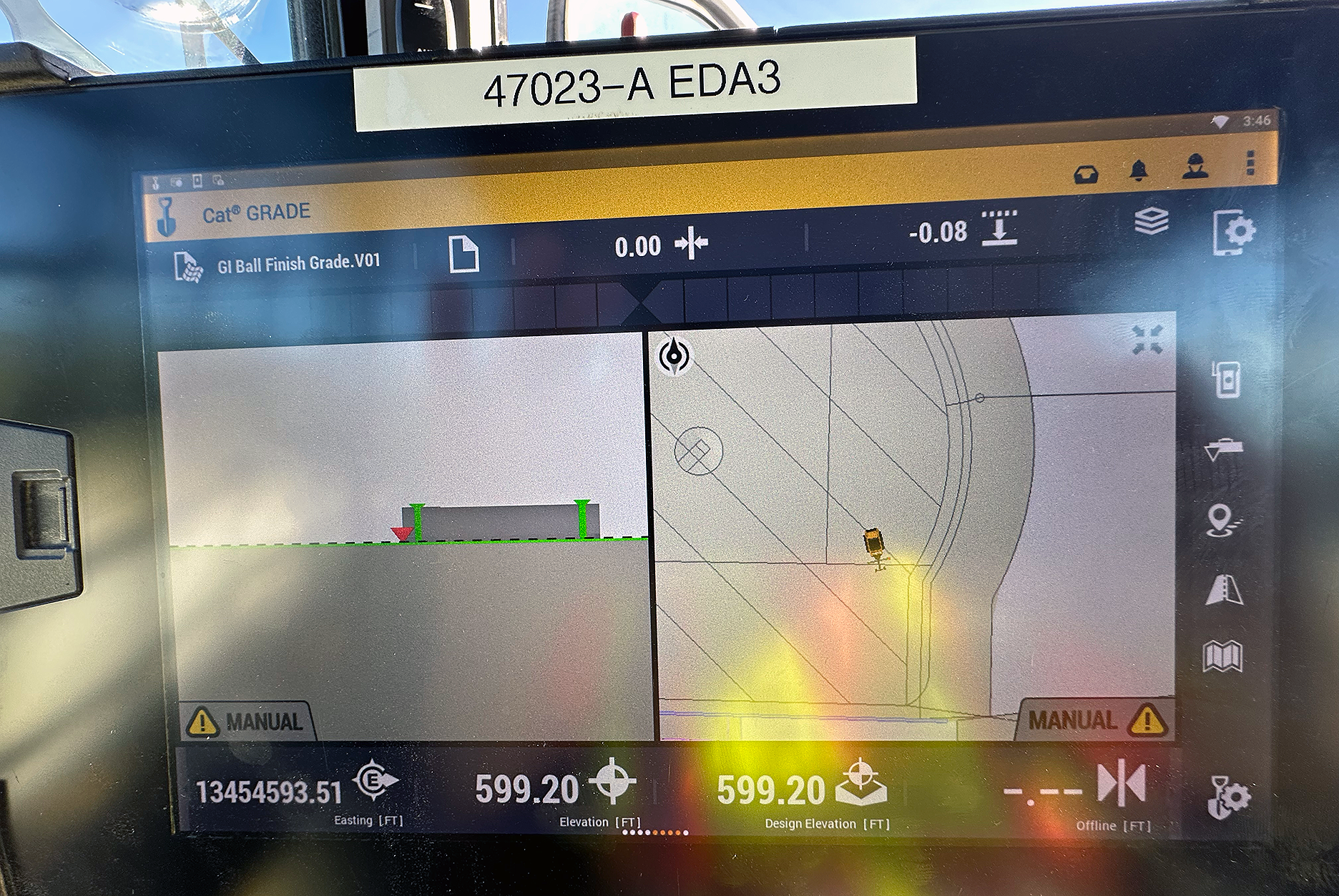A bulldozer GPS vehicle display screen showing a top view of a vehicle on a site map, elevation and design elevation readings.