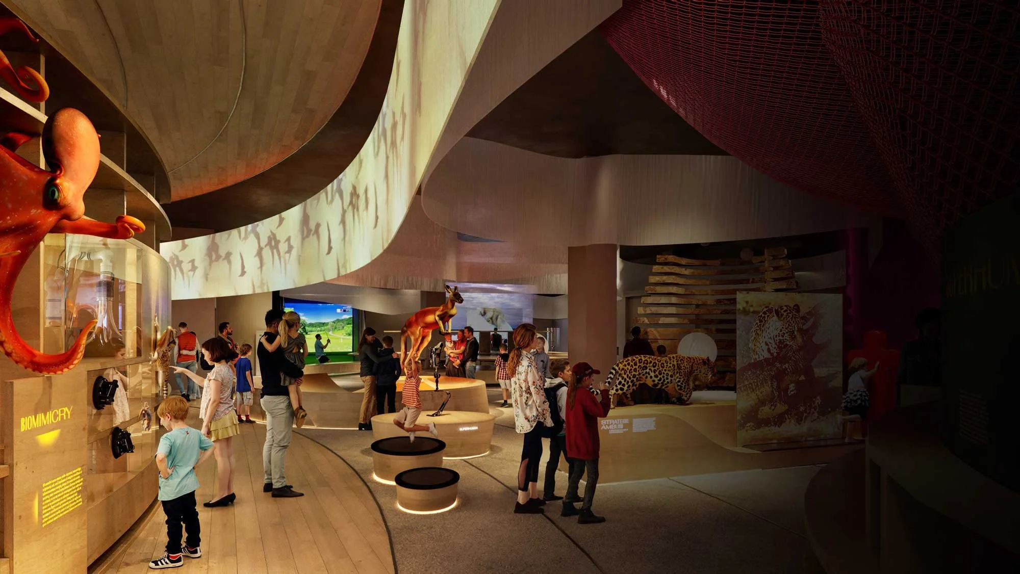 Children and adults exploring an indoor museum with animal exhibits, including a large octopus, a giraffe statue, and a leopard display, with informational panels and digital screens.