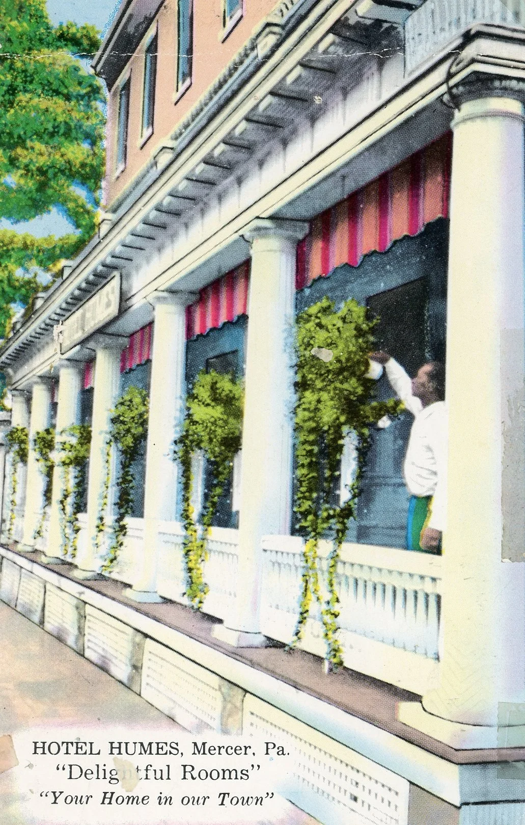 Vintage postcard of Hotel Humes in Mercer, Pennsylvania, showing a building with tall white columns, greenery, and a person standing on the porch wearing a face mask.