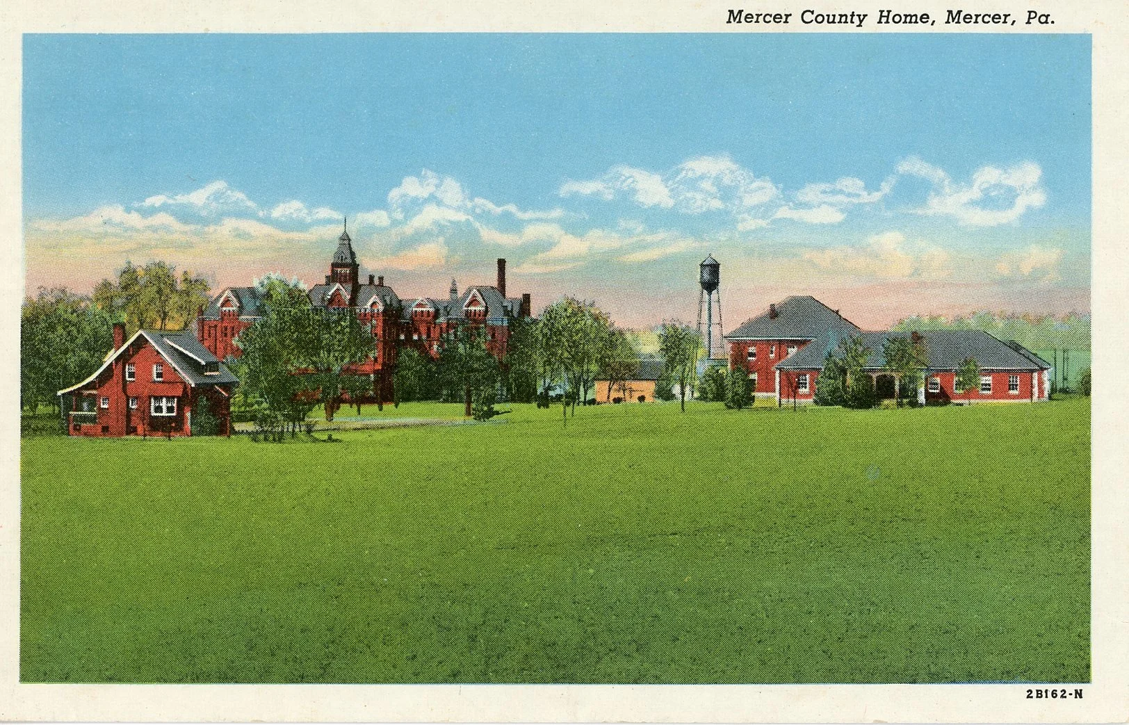 Illustration of Mercer County Home in Mercer, Pennsylvania, featuring several red brick buildings, a water tower, lush green trees, and a expansive grassy foreground with a partly cloudy sky.
