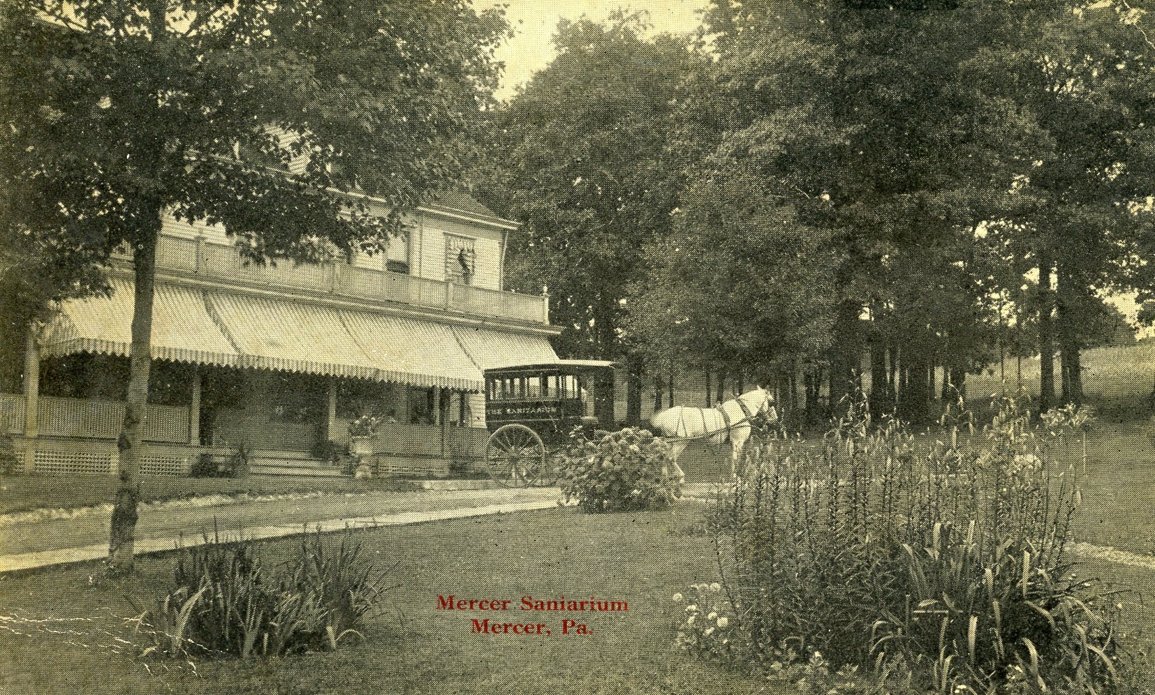 Historical black and white photograph of Mercer Sanitarium in Mercer, Pennsylvania, featuring a large building with an awning, a horse-drawn wagon, and a garden with plants and flowers in the foreground.