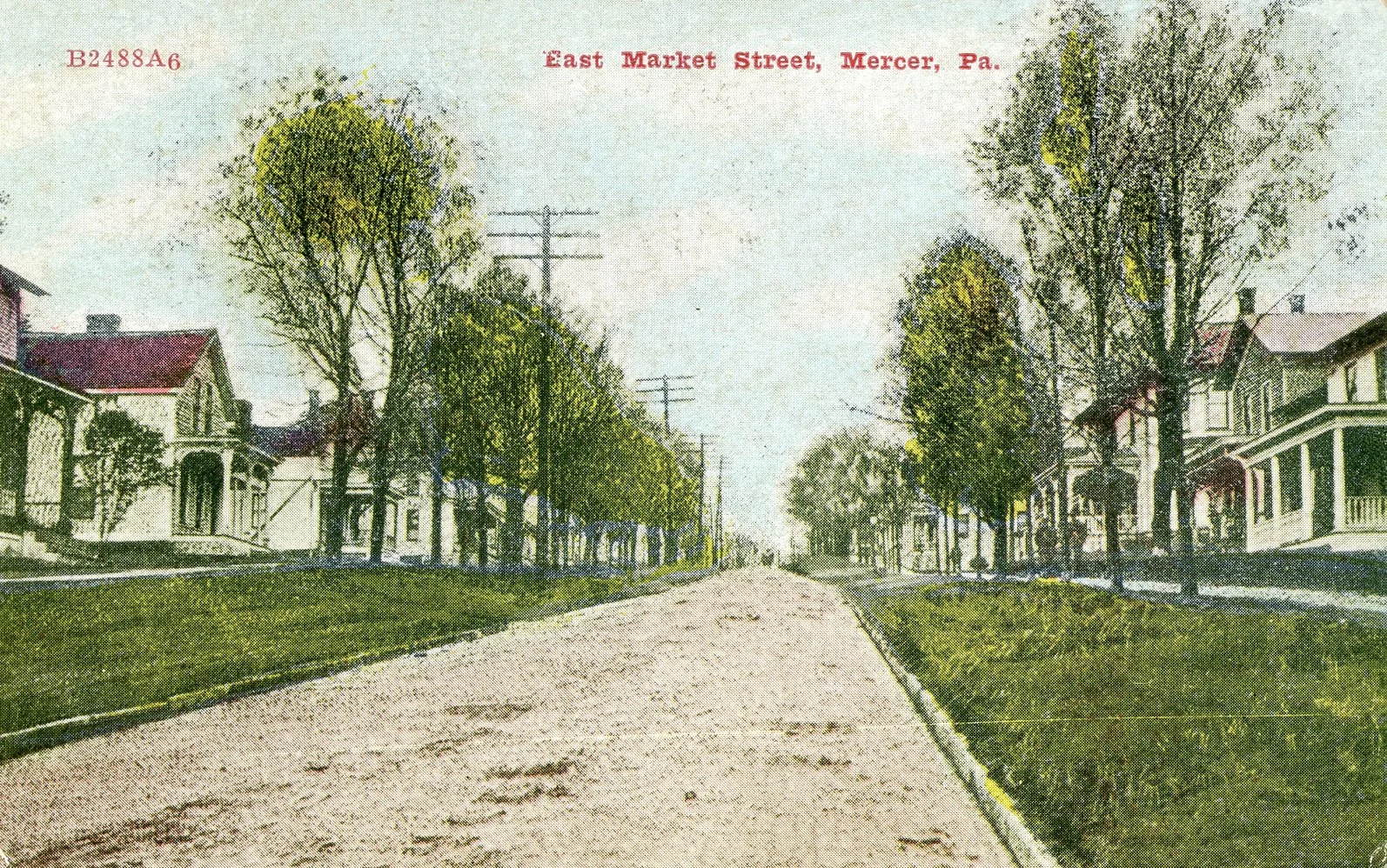 Historical black and white photograph of East Market Street in Mercer, Pennsylvania, showing trees lining both sides of a dirt road with houses and telephone poles.