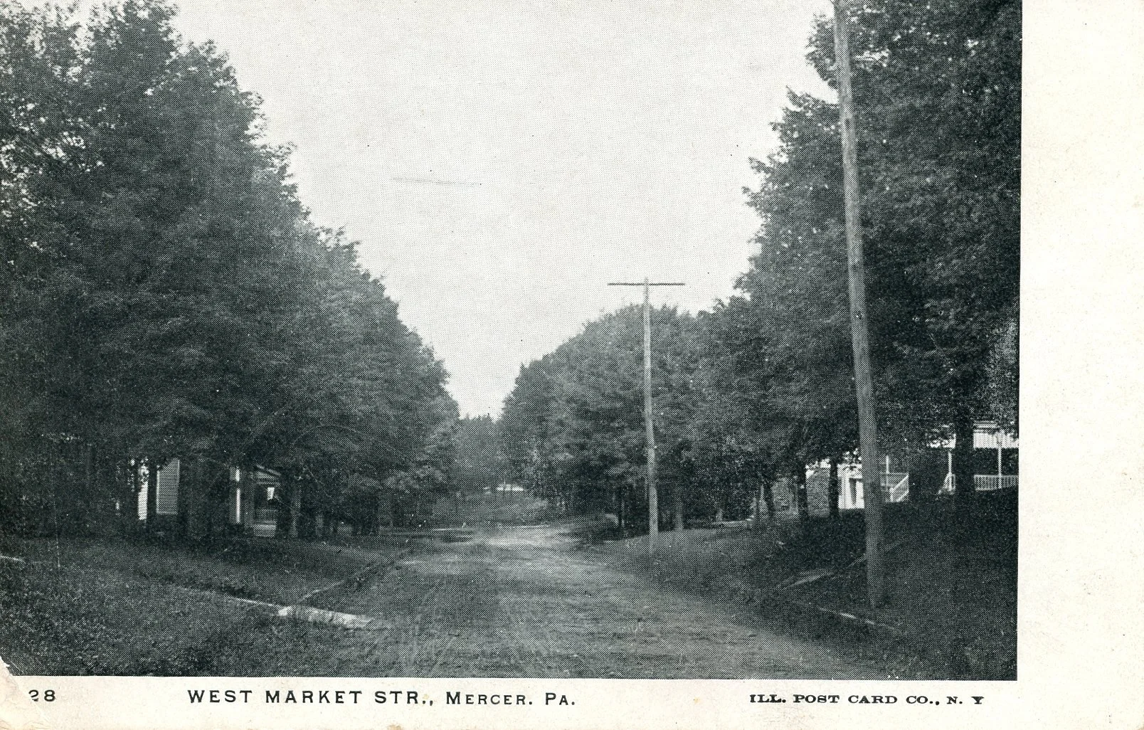 Black and white photograph of West Market Street in Mercer, Pennsylvania, showing a tree-lined street with utility poles and houses on both sides.
