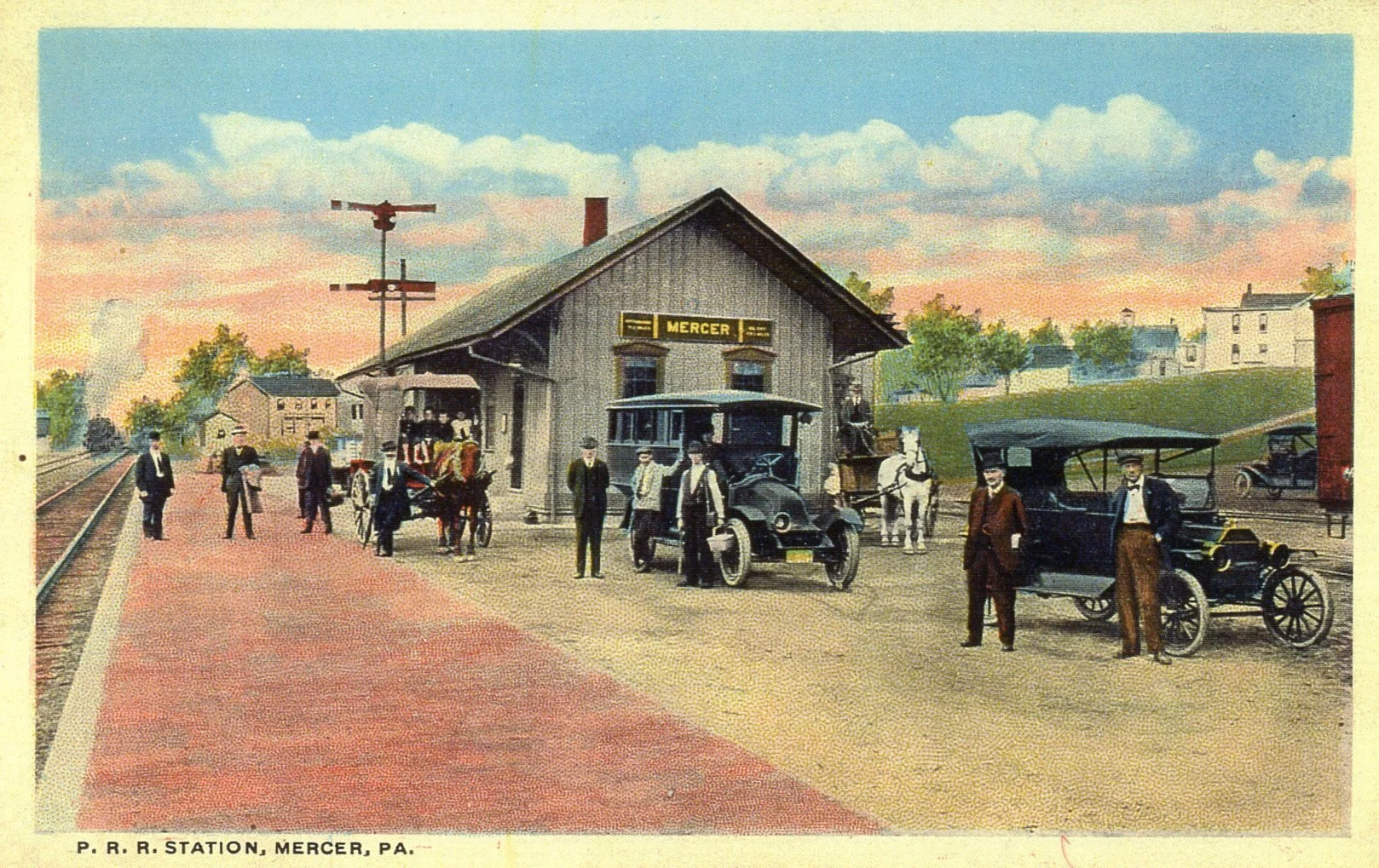 Colorized vintage illustration of P.R.R. station in Mercer, Pennsylvania, showing an old train station building with a sign reading 'Mercer.' Several early 20th-century automobiles and people, including men in suits and hats, are gathered outside the