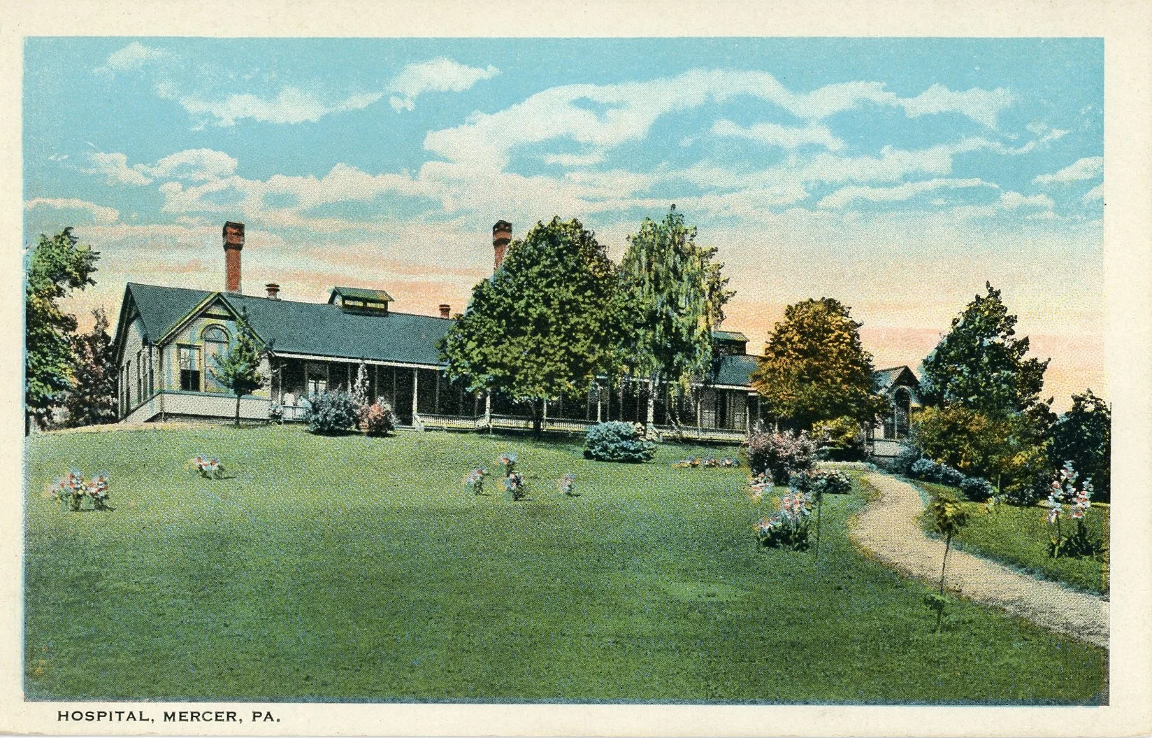 Vintage postcard of Mercer Hospital in Pennsylvania, featuring a large, historic building surrounded by a green lawn with trees and a winding pathway.