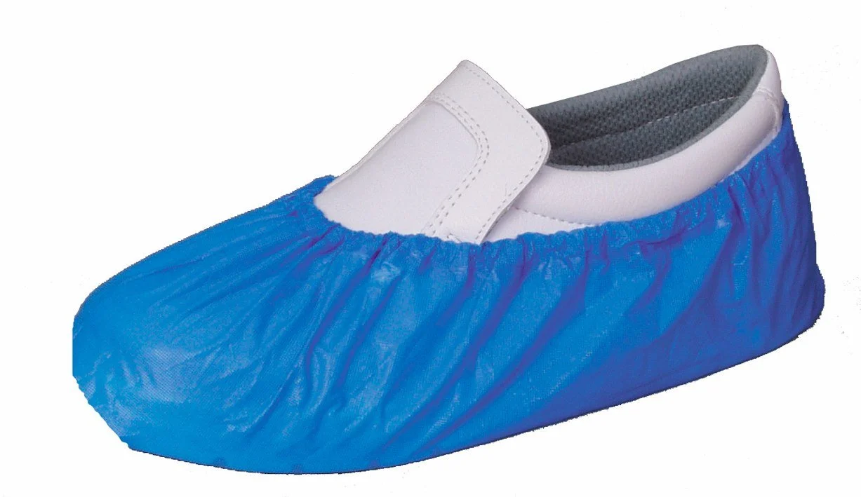Disposable shoe cover over a white slip-on shoe with gray interior lining.
