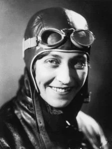 Photo of Amy Johnson wearing her pilot's helmet and goggles