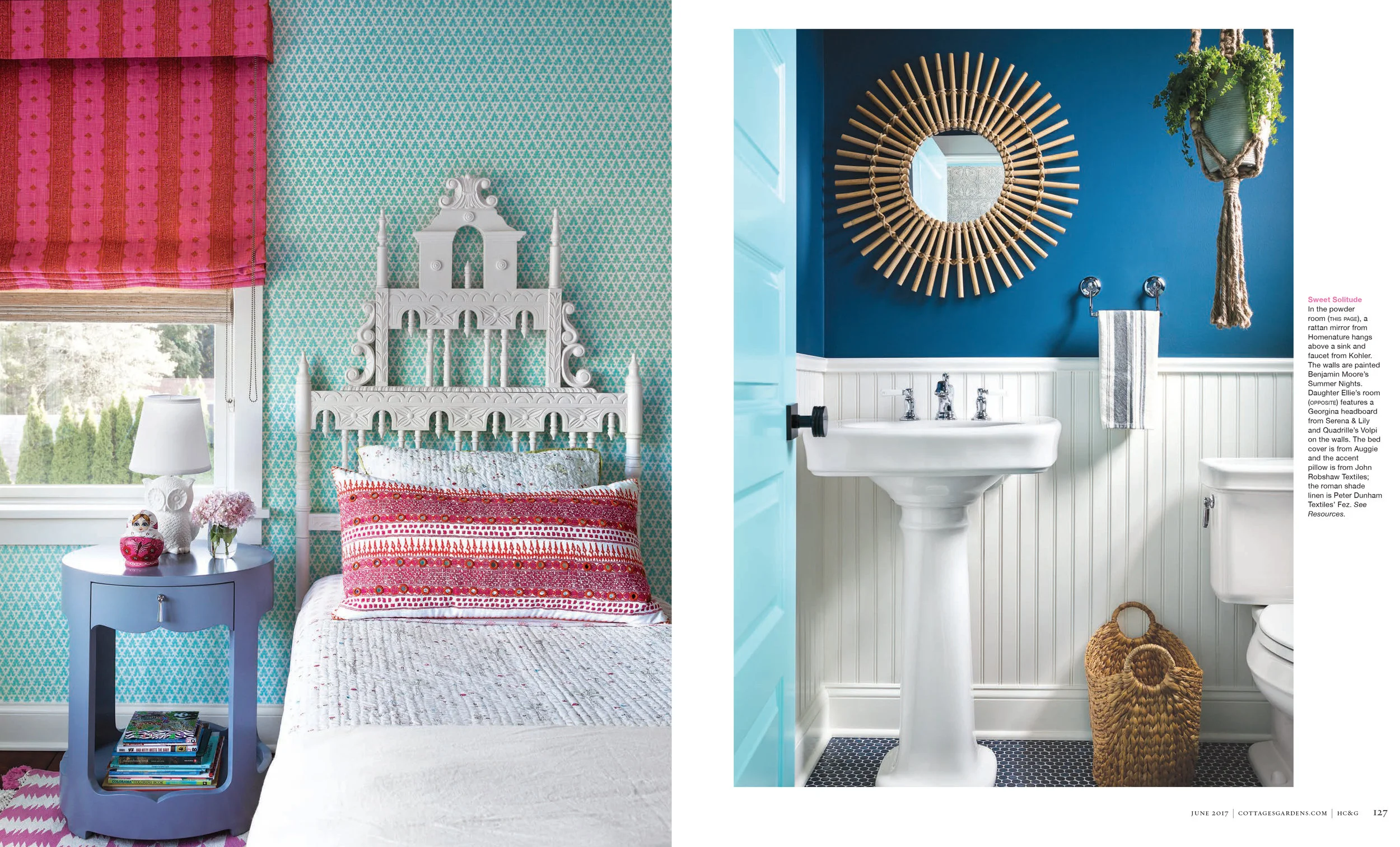 Interior of a bedroom with patterned turquoise and pink wallpaper, a white ornate headboard, pink patterned pillow, next to a window with pink-tan curtain, and a blue nightstand with books, a lamp, and decorative items. Bathroom features blue wall, w