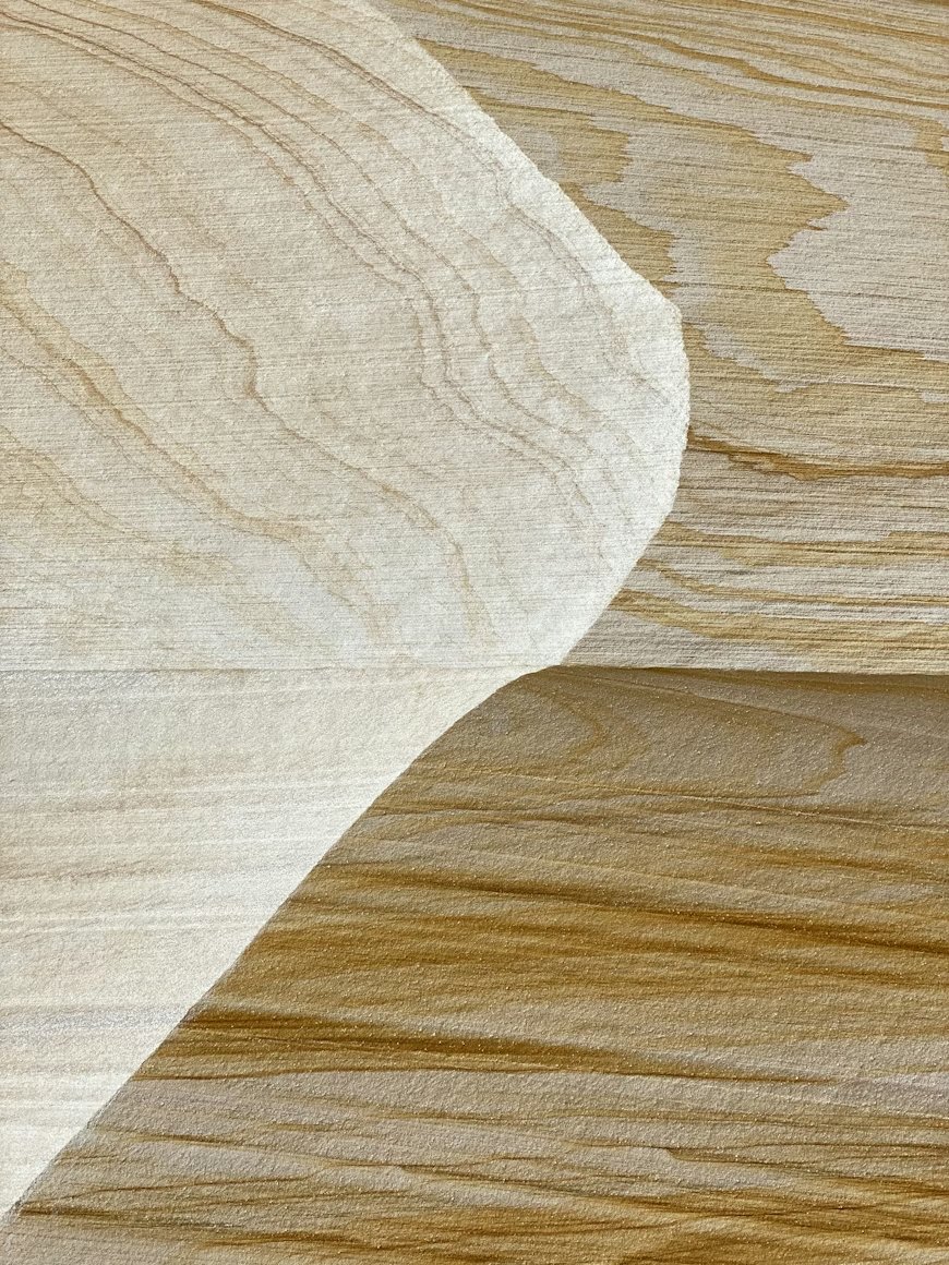 Close-up of natural wood grain with light and dark streaks.