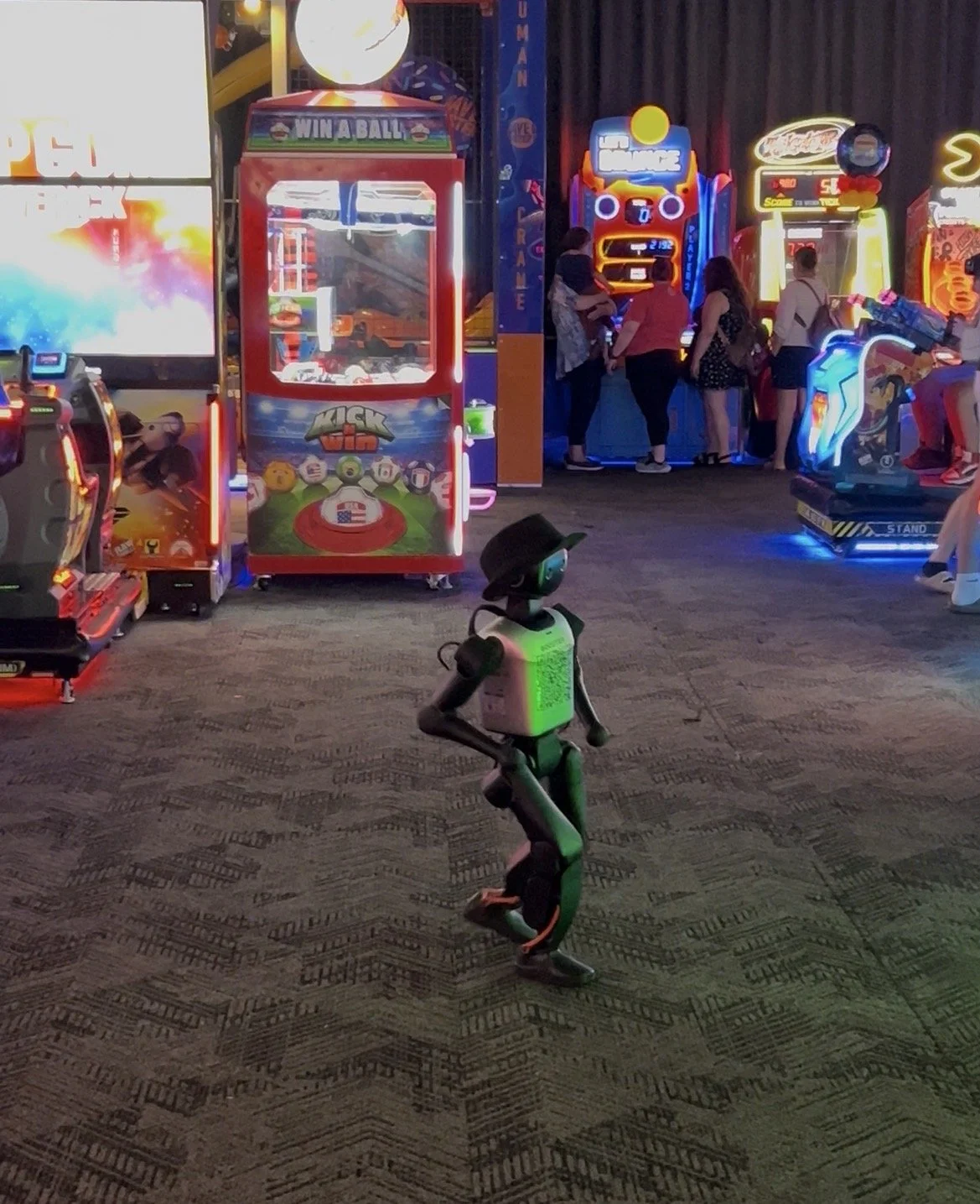 Kai, a humanoid robot walking in an arcade at Dave and Busters
