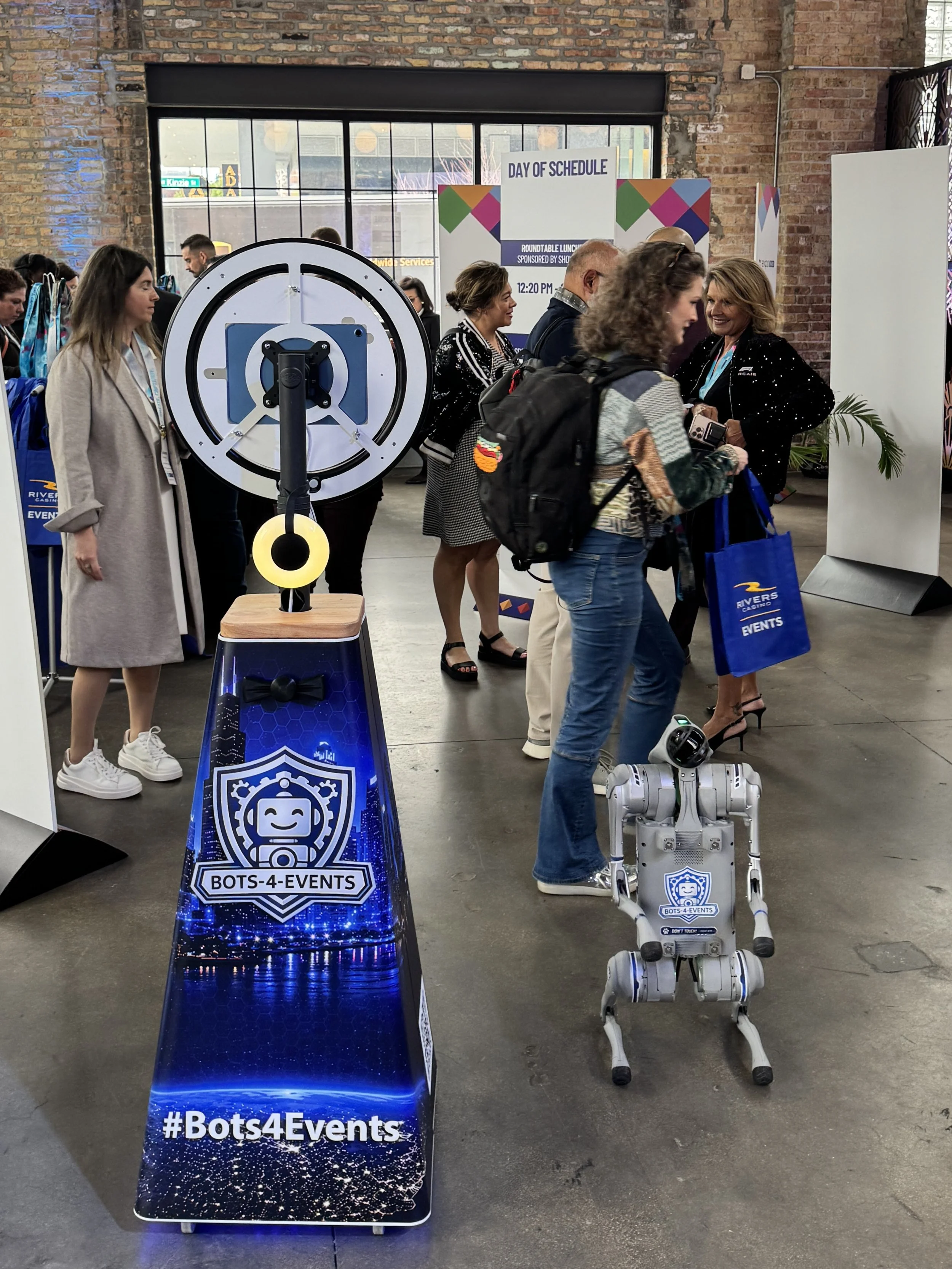 Eve The Robot Dog and SelfieBot at a technology exhibit.