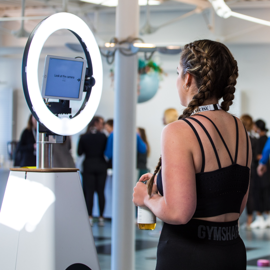 Guests entertained by Draw Me Bot waiting for their picture to draw