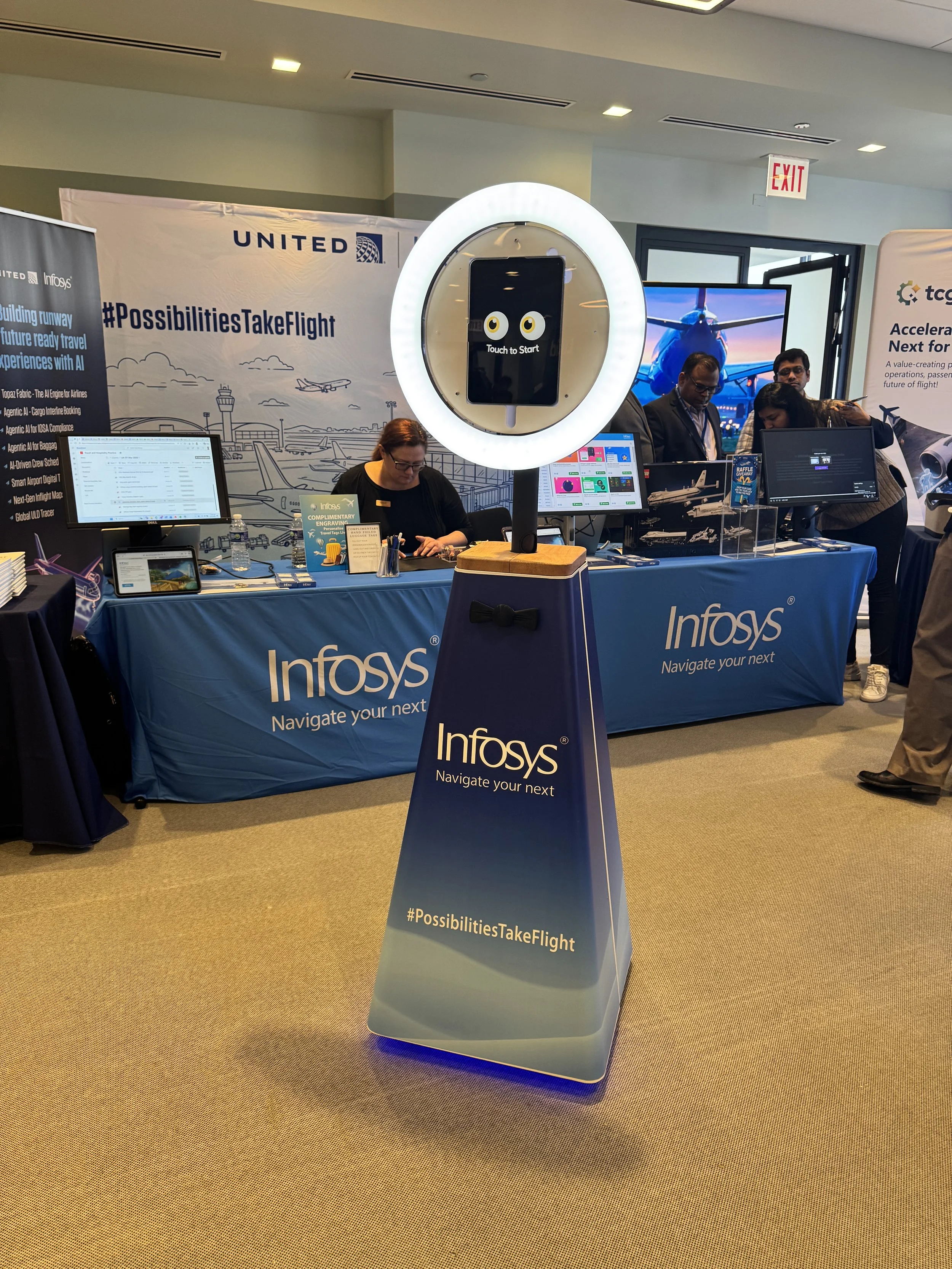SelfieBot fully branded with Infosys logo matching their booth creating a highly engaging experience for any attendee who visits the booth. Attendees receive a fun printed, SMS, or emailed photo branded with Infosys logo and conference information.