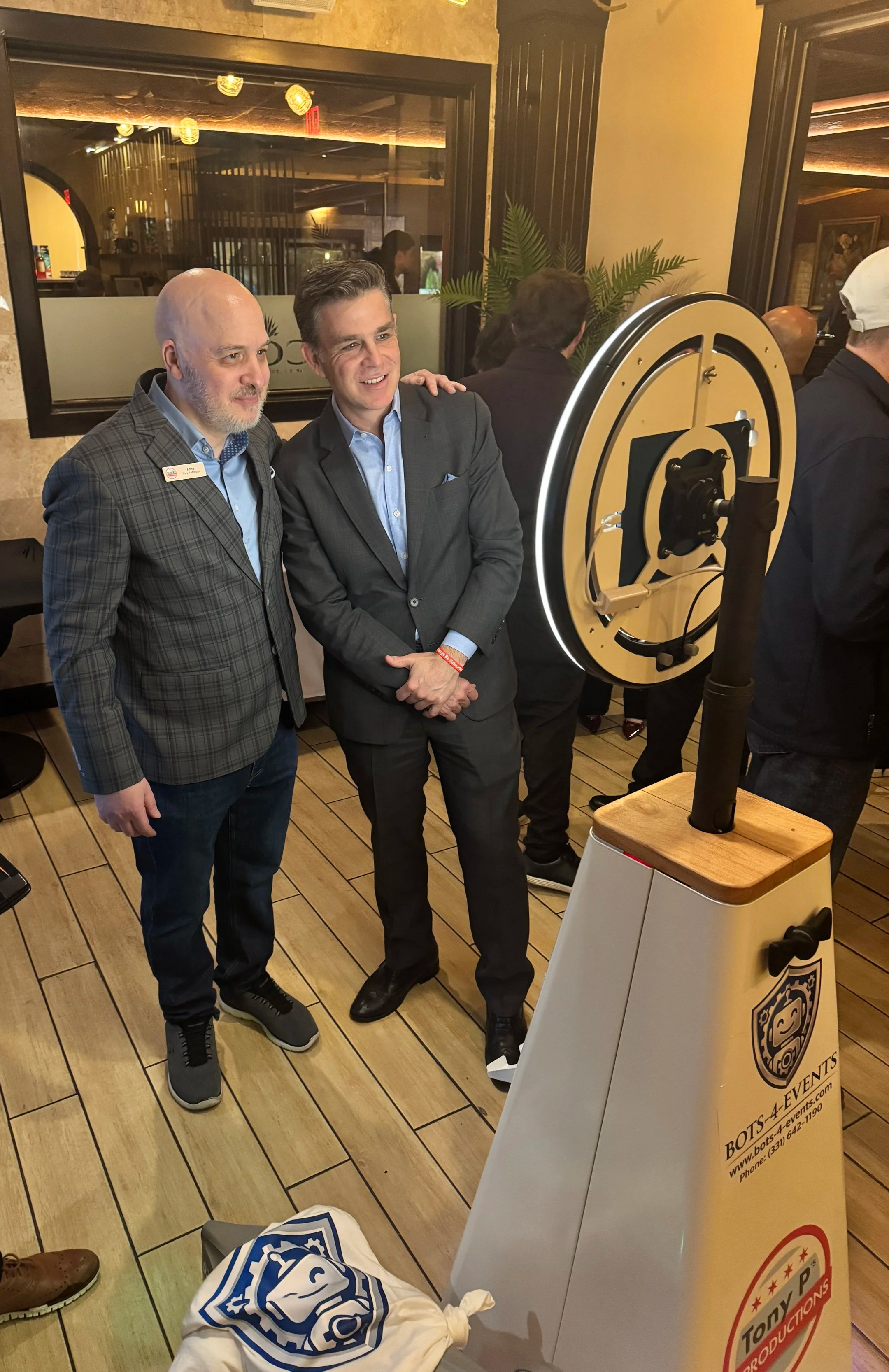 SelfieBot and RoboDog at a Marketing Event taking a selfie picture while robodog hangs out on the side waiting to do fun tricks.