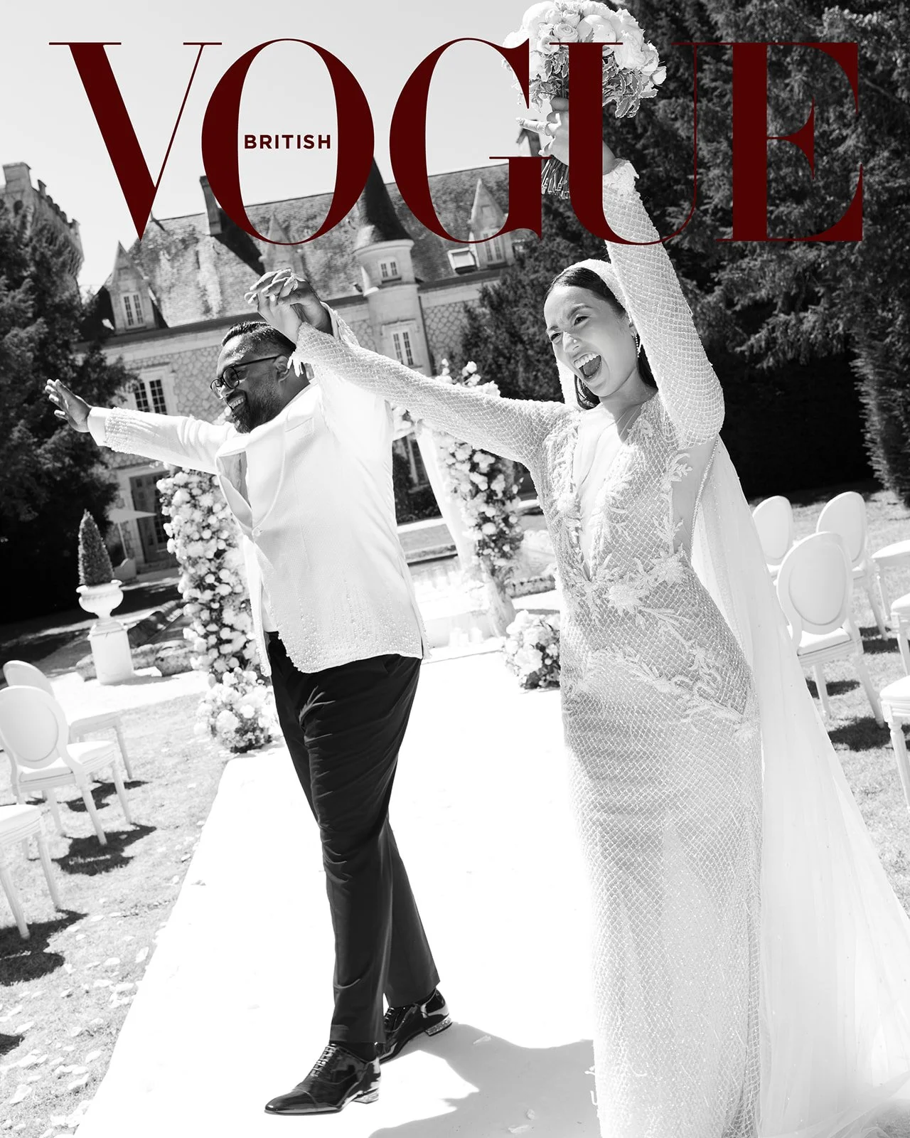 A black and white photo of a wedding couple happily celebrating outdoors, with the woman holding a bouquet and both with arms raised. Featured in Vogue .