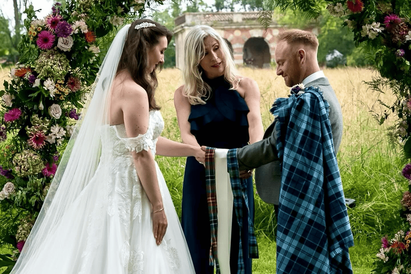 A couple get married at Chateau de Bourneau. With a traditional hand fasting ceremony and the groom wearing Scottish attire.