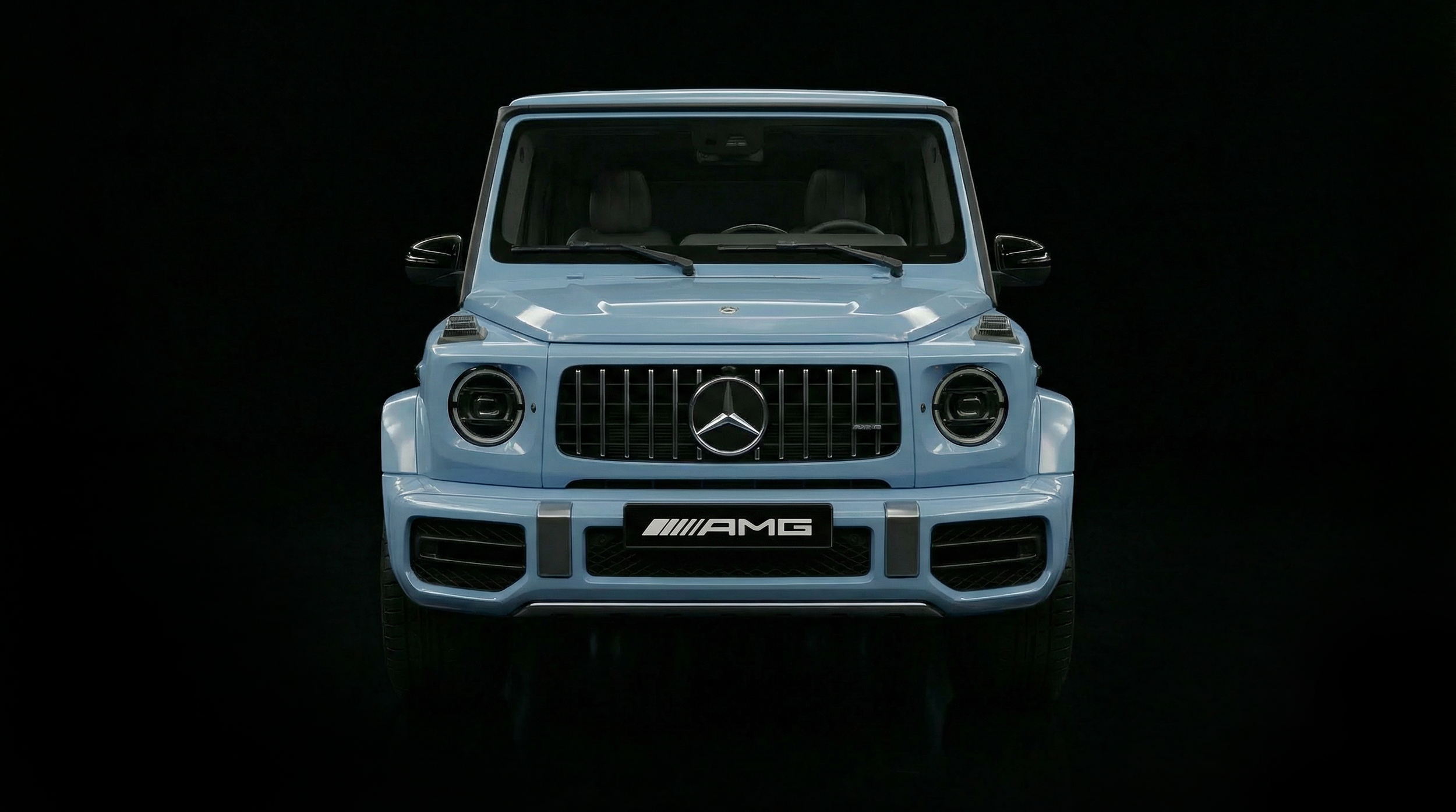 Front view of a light blue Mercedes-Benz G-Class SUV with AMG badging, set against a black background
