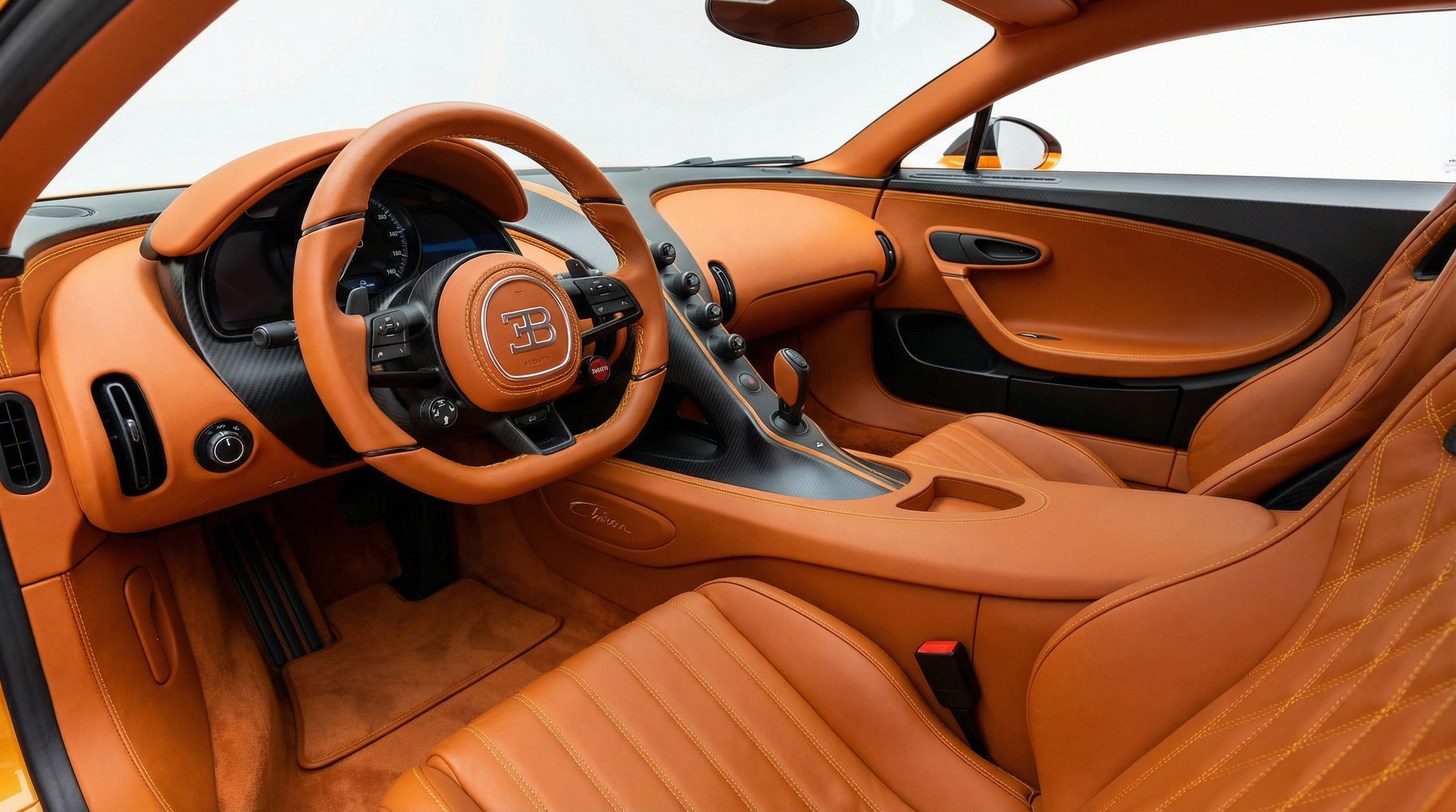 Inside view of a luxury sports car with tan leather interior, including a steering wheel, dashboard, and seats.
