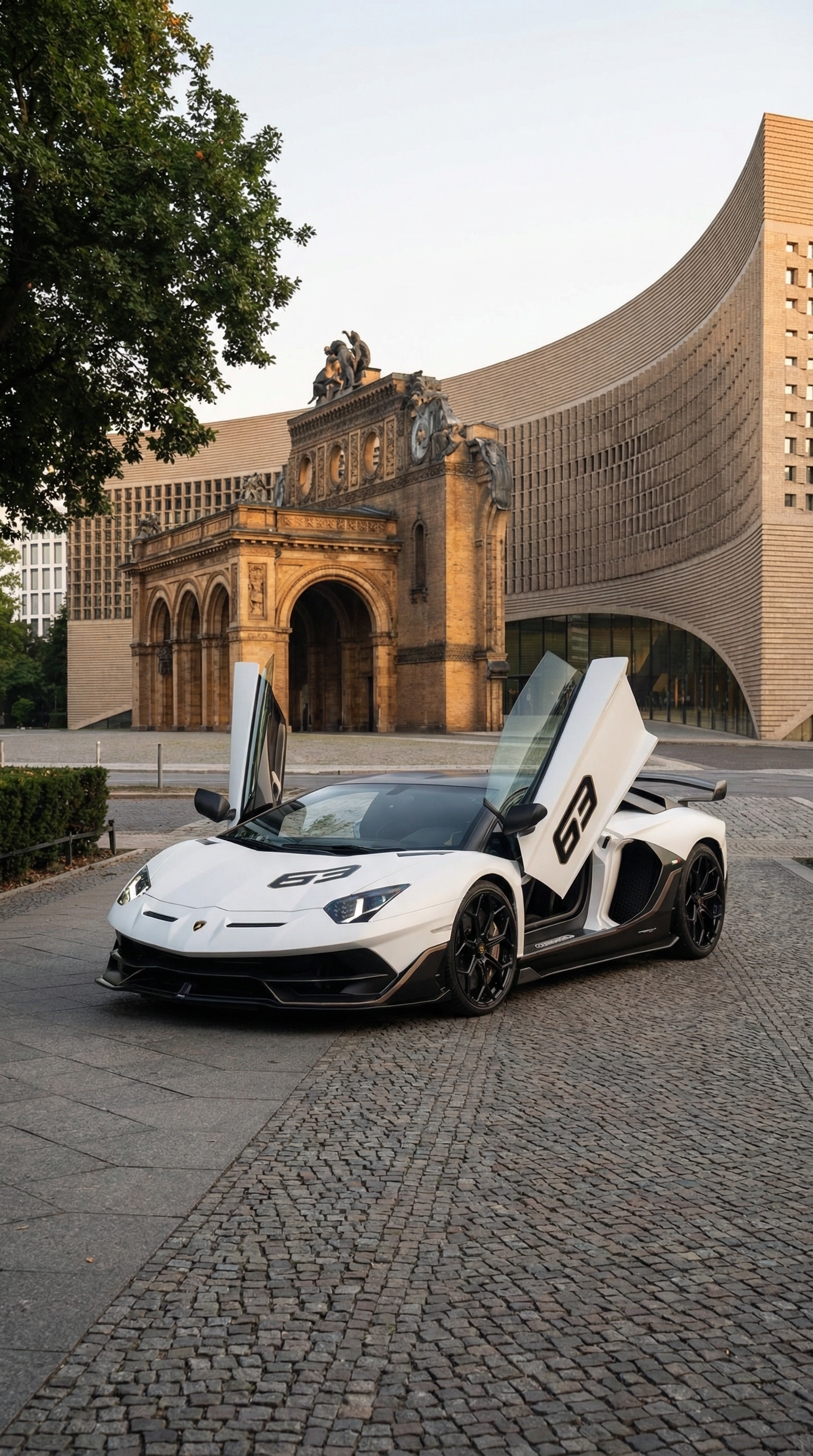 A white Lamborghini sports car with gullwing doors open is parked on a city street, with a historic arch and modern building in the background.
