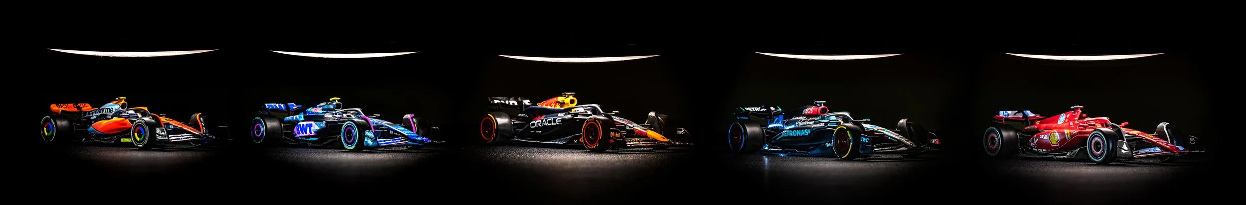 Multiple Formula 1 Cars in a studio photography setting