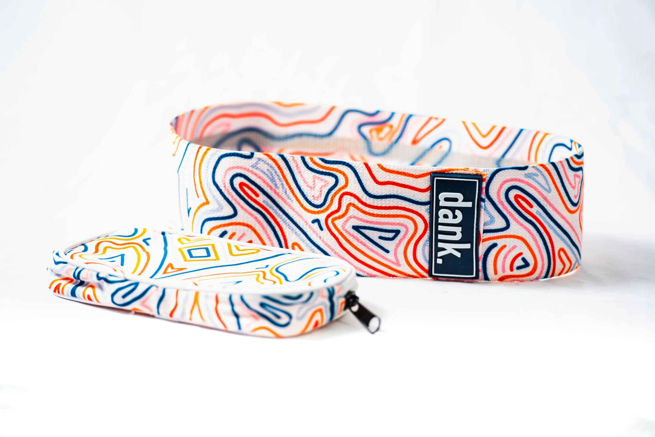 A colorful patterned headband and matching pouch with a multicolored abstract design.