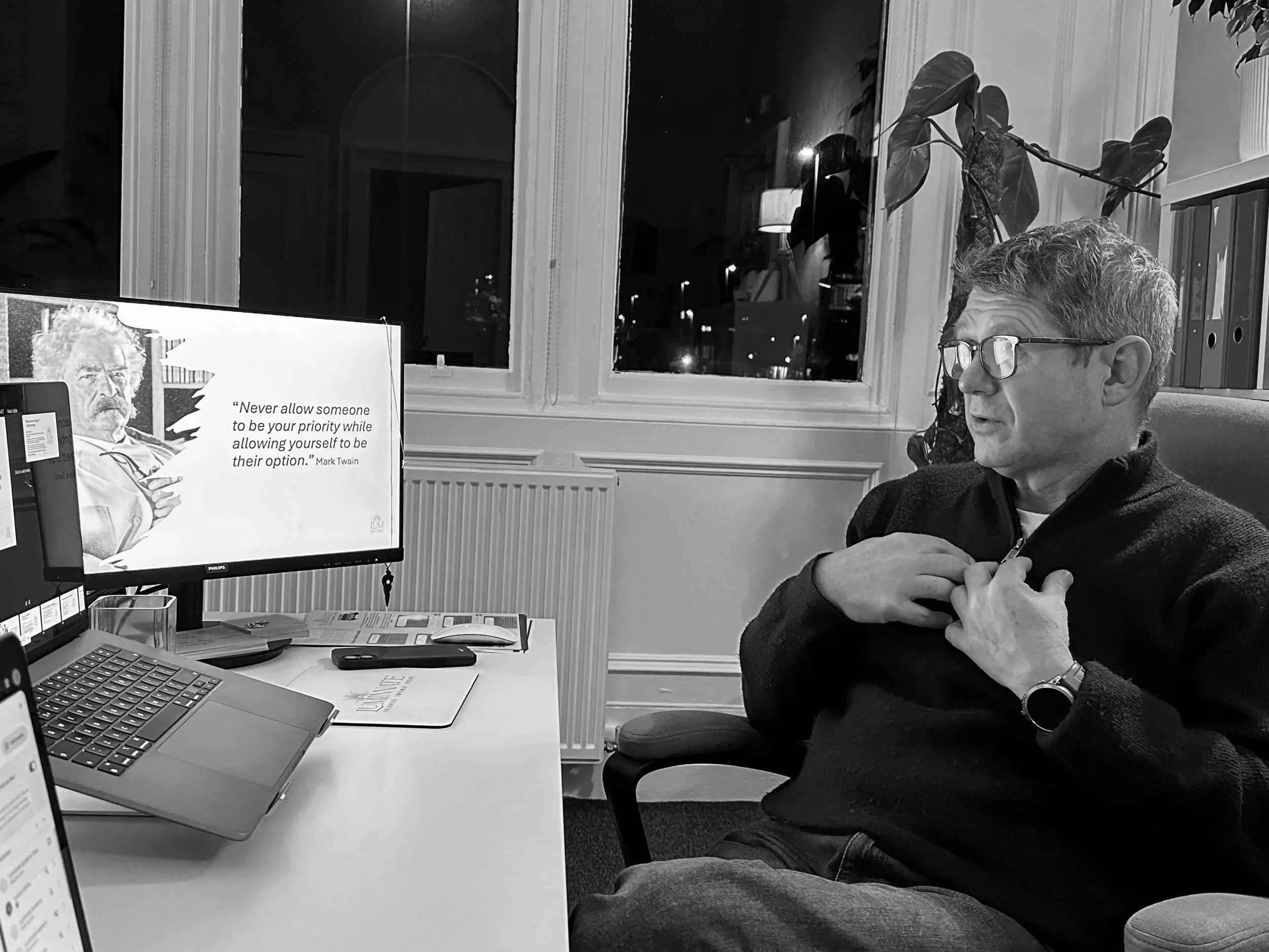 Silhouettes of six people standing on a hill at sunset, making peace signs with their hands.