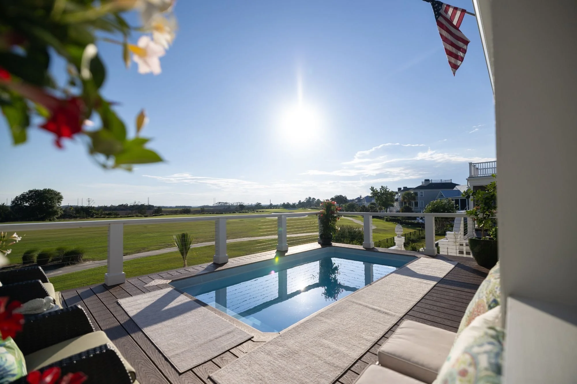 Plungie plunge pool installation in Chesterfield Missouri on elevated deck with modern railing and scenic backyard view