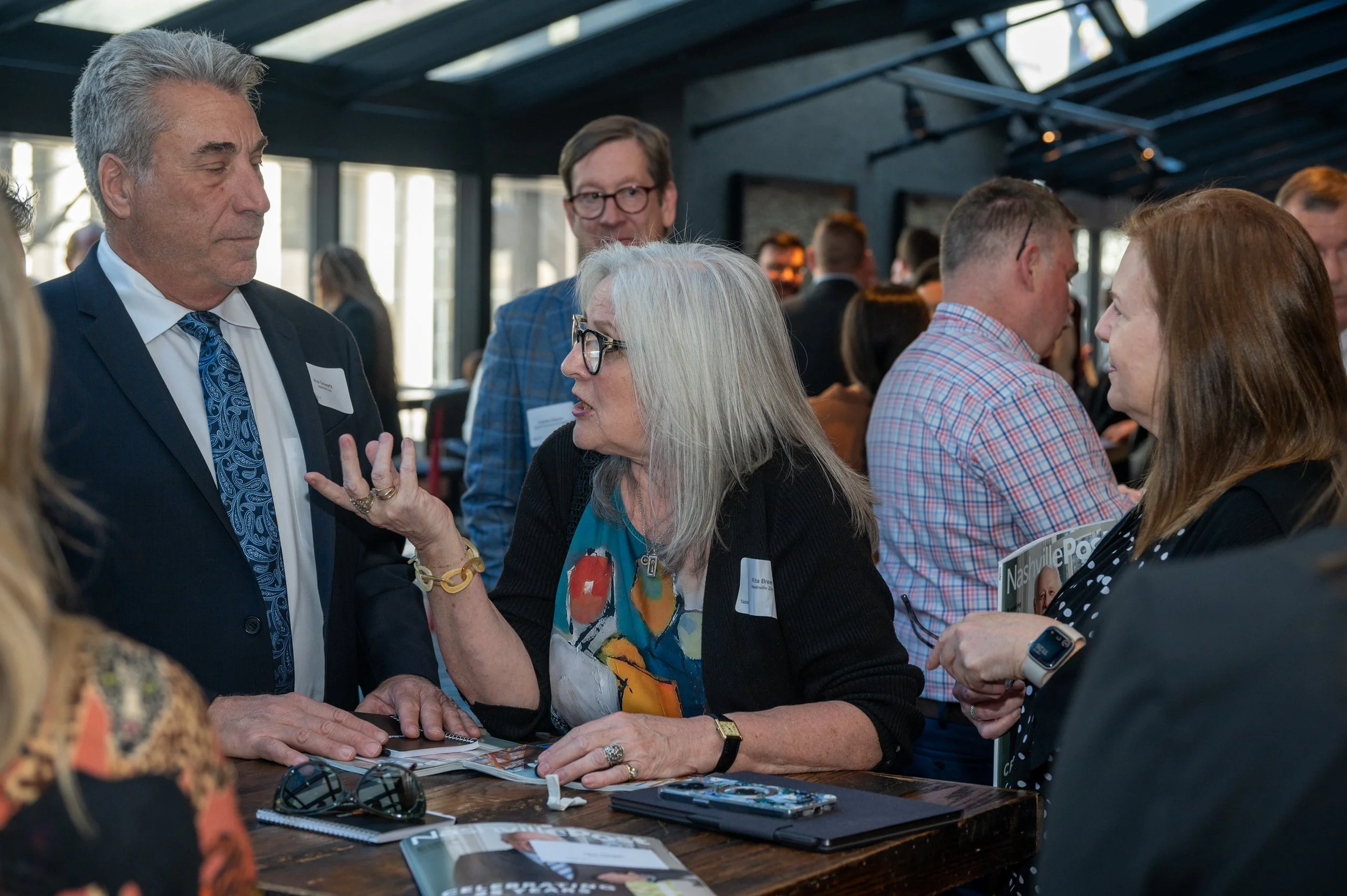People engaged in conversation at a networking event or conference.