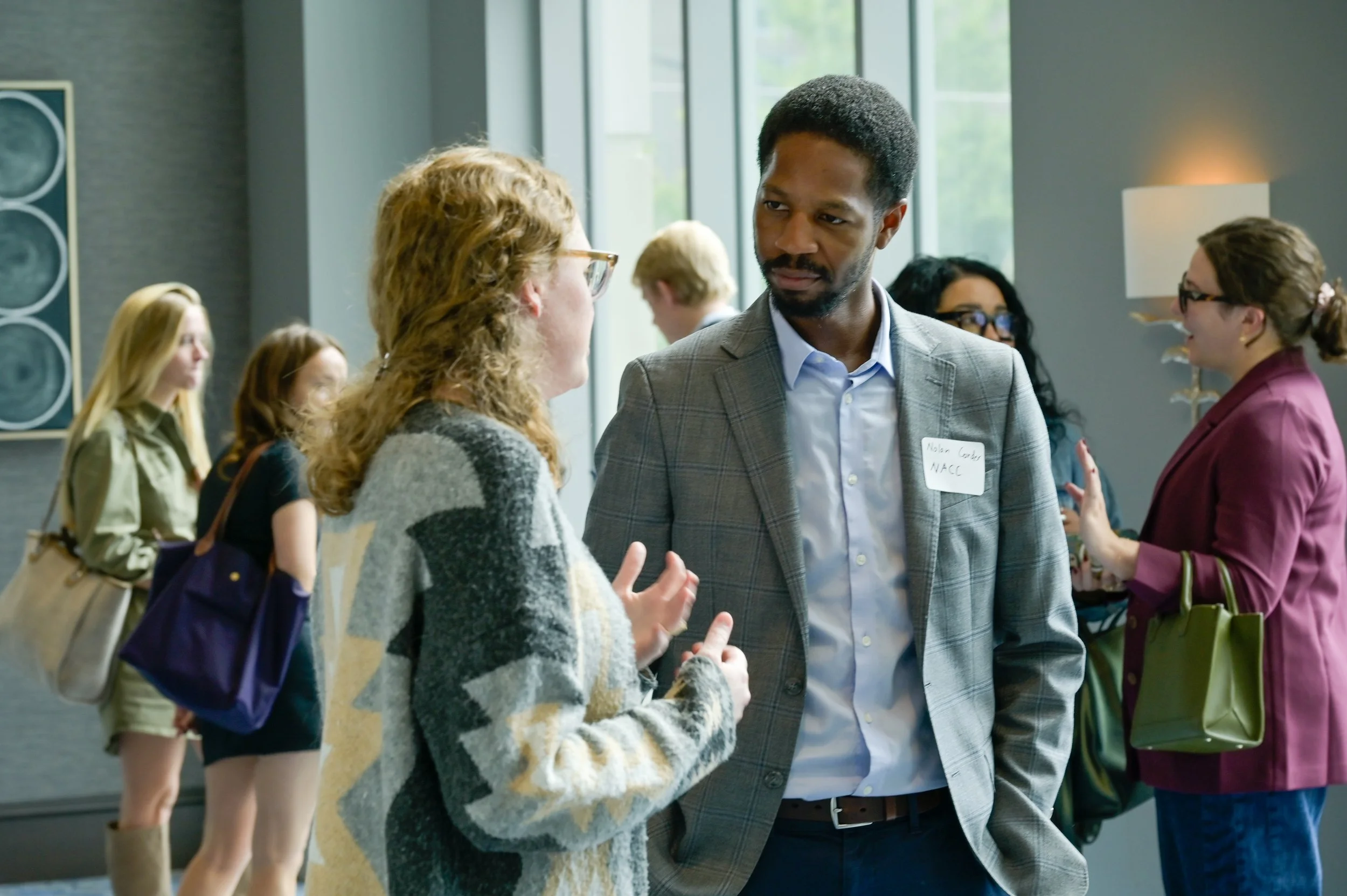 People networking and chatting at a professional event or conference