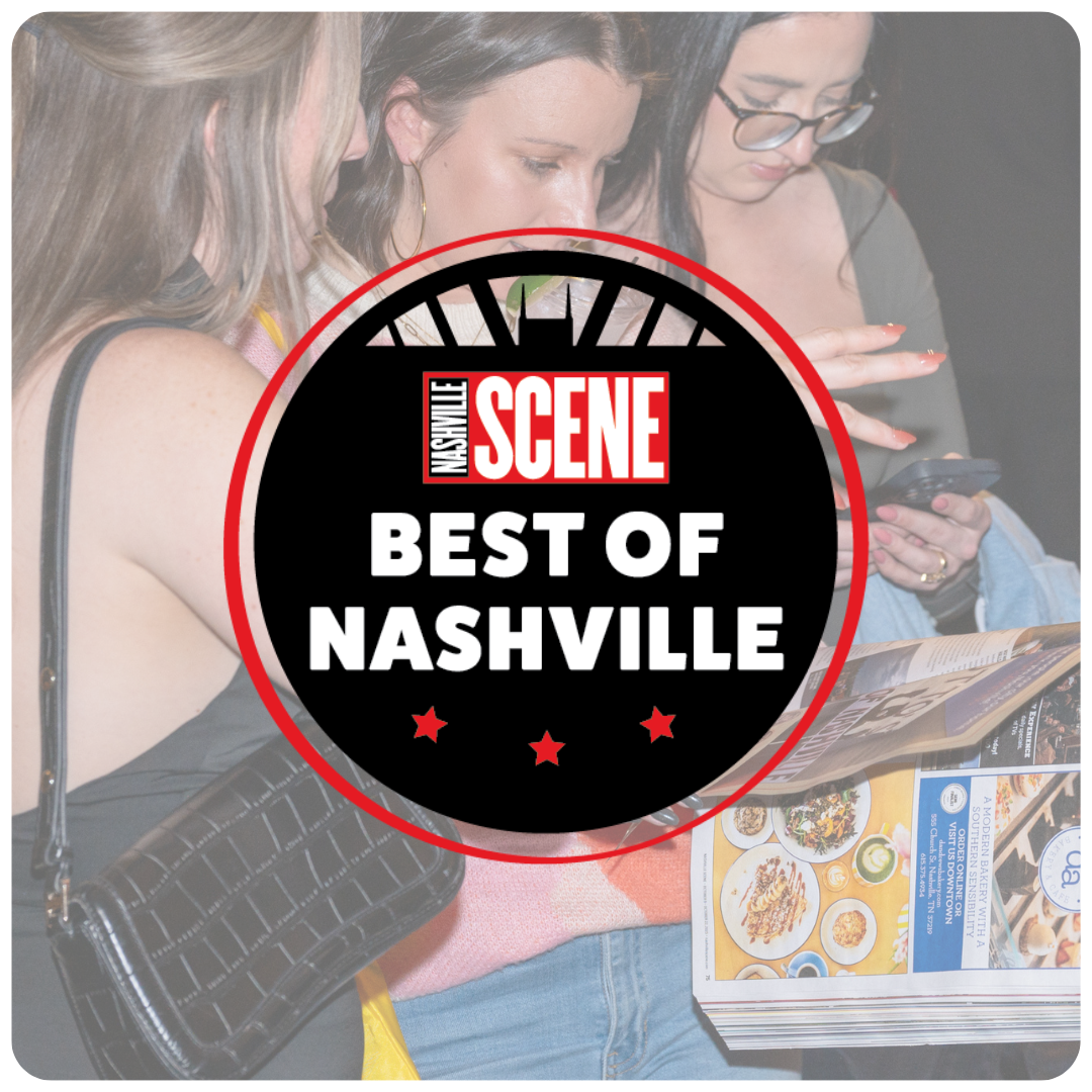 A group of women looking at a smartphone and a magazine in a restaurant or cafe with a Nashville Scene logo overlay that reads 'Best of Nashville'.