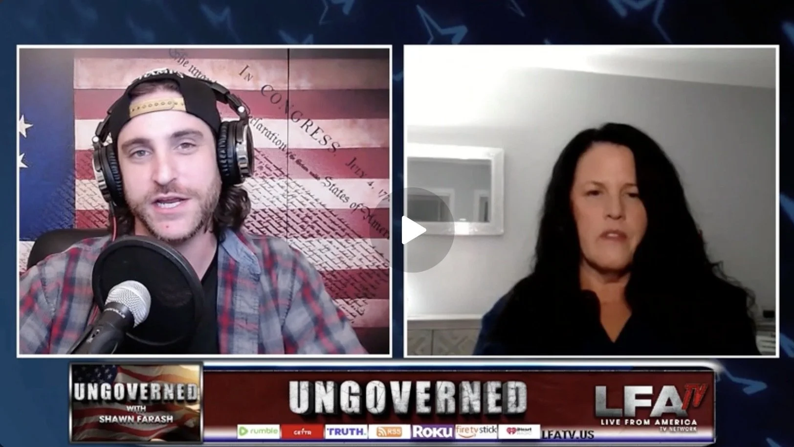 A man with long hair and a beard wearing a baseball cap backwards, plaid shirt, and headset speaking into a microphone on a video call, with a woman with long black hair and black shirt in a room with gray walls on the screen, behind them a screen displays the word 'UNGOVERNED' and the logo of LEATV.