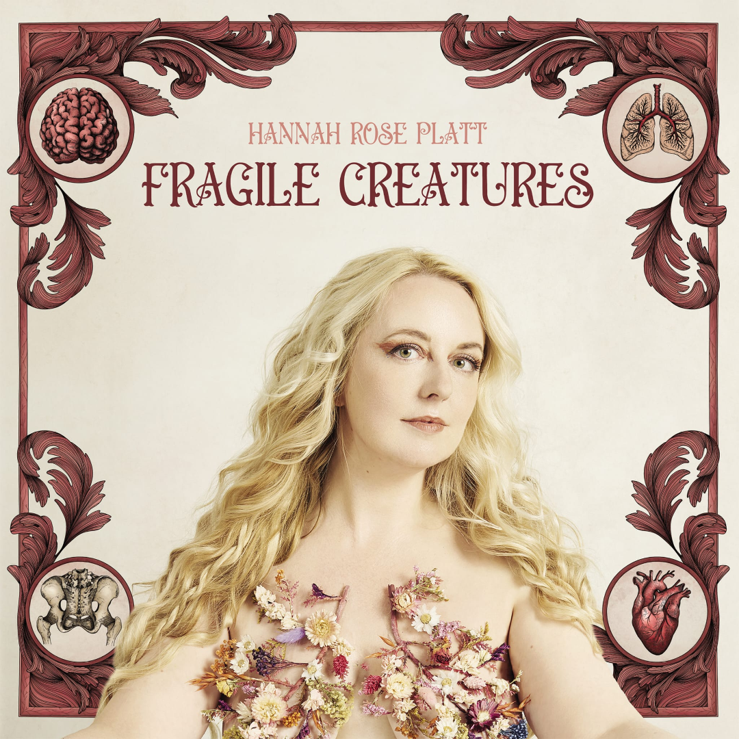 Book cover featuring a woman with long blonde hair and floral decorations on her chest, surrounded by illustrations of a brain, lungs, pelvis, and heart, with a decorative red border and the title 'Fragile Creatures' by Hannah Rose Platt.