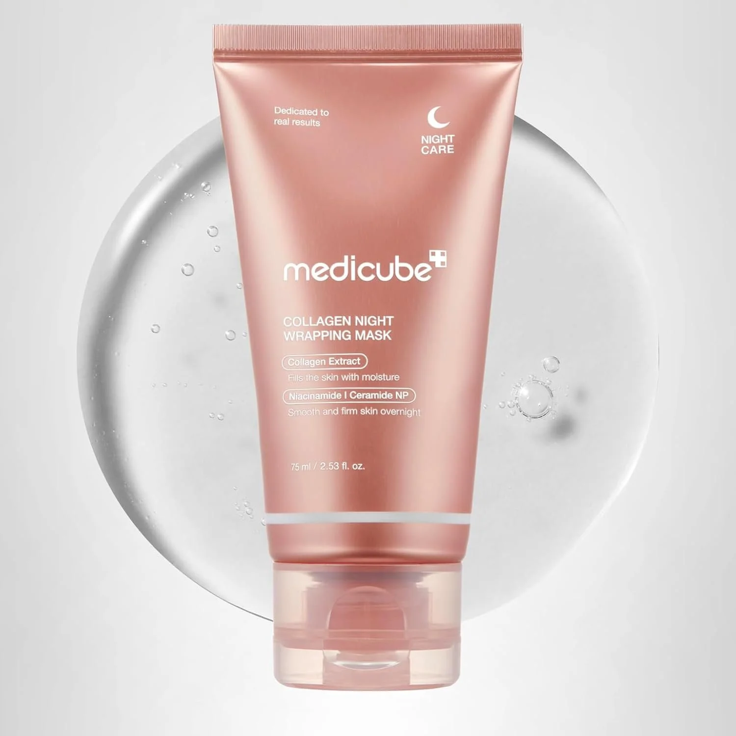 A pink tube of medicube Collagen Night Wrapping Mask with a white circular background containing water droplets.