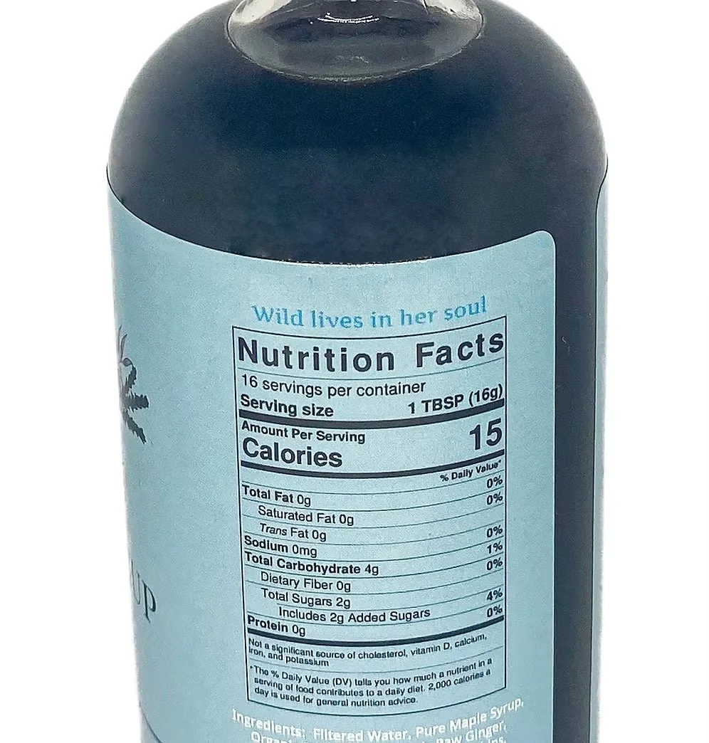 Close-up of vegan elderberry syrup label highlighting honey-free and maple syrup ingredients
