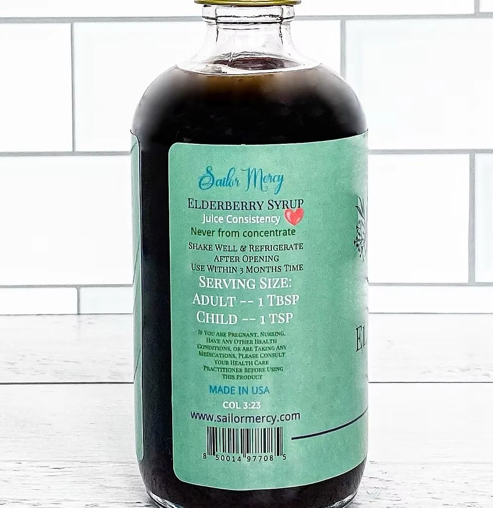 Close-up of elderberry syrup bottle label showing organic ingredients and immune support tonic