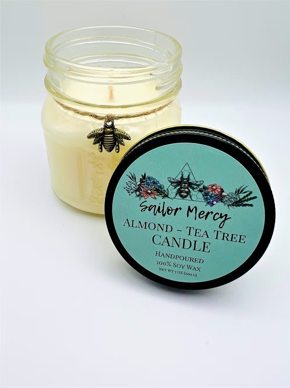 Sailor Mercy almond tea tree soy wax candle in glass jar with herbal scent
