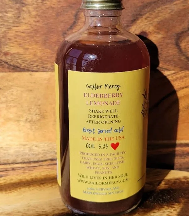 Side view of elderberry lemonade bottle with product details