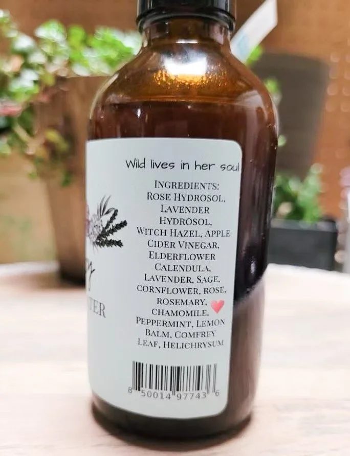 Back label of Sailor Mercy herbal facial toner showing ingredients and product details on amber glass bottle